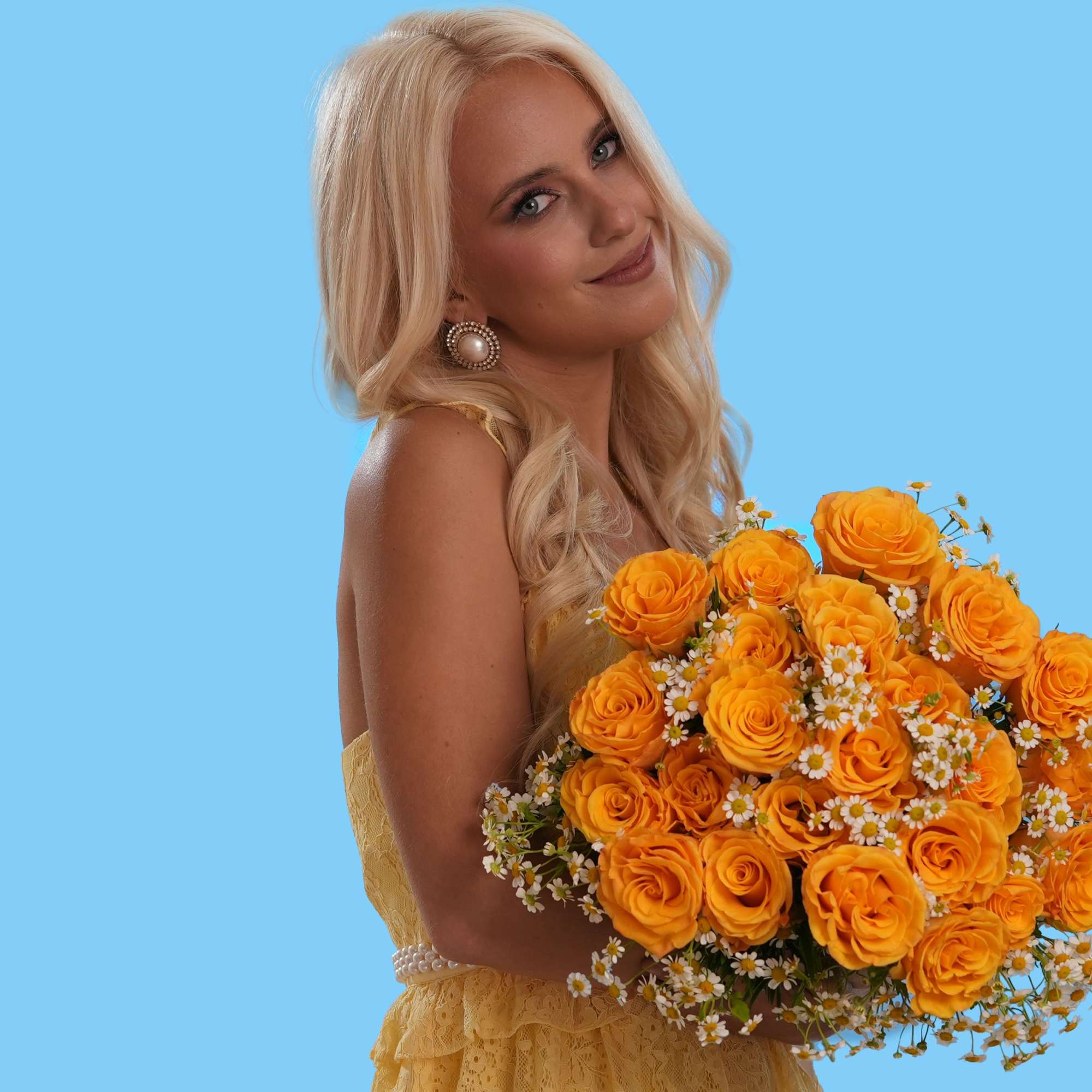 Woman holding a bouquet of orange roses and small white flowers