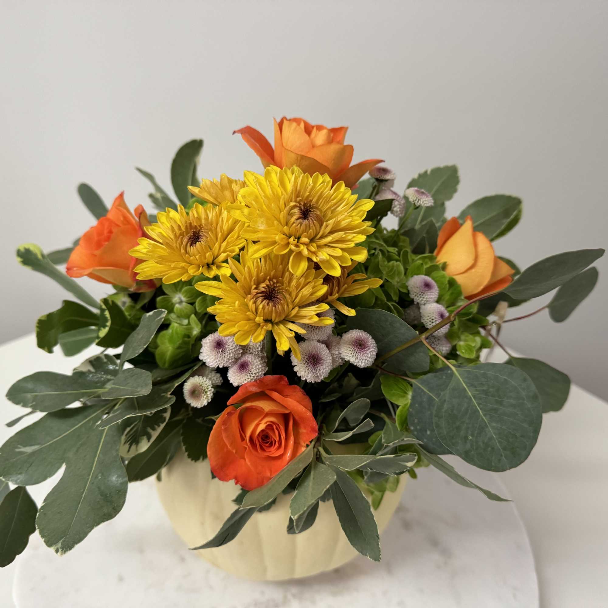 A natural and fresh pumpkin with flowers with  fall colors the