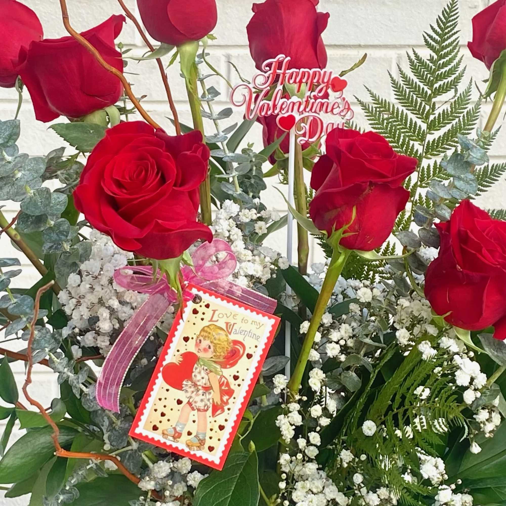 Red roses with baby's breath and a Valentine's Day tag