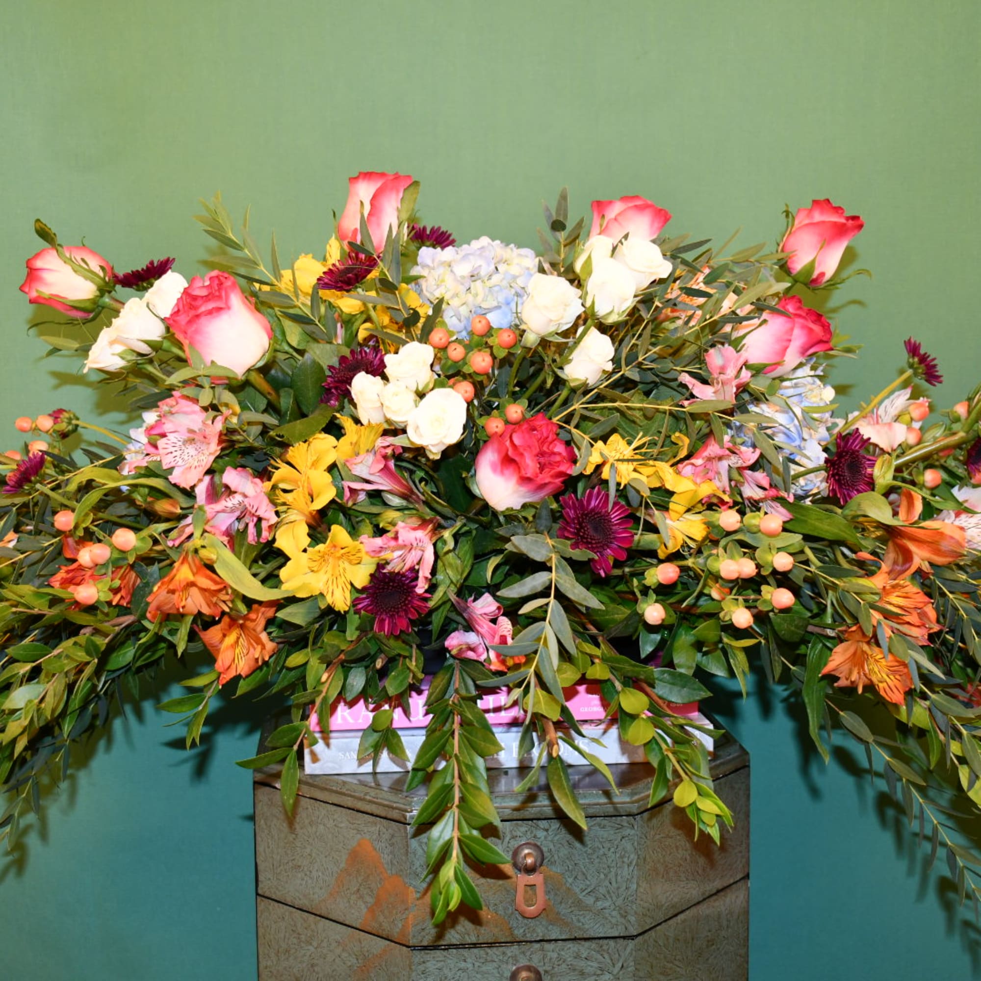 Large mixed bouquet with pink roses, white blooms, and colorful filler flowers