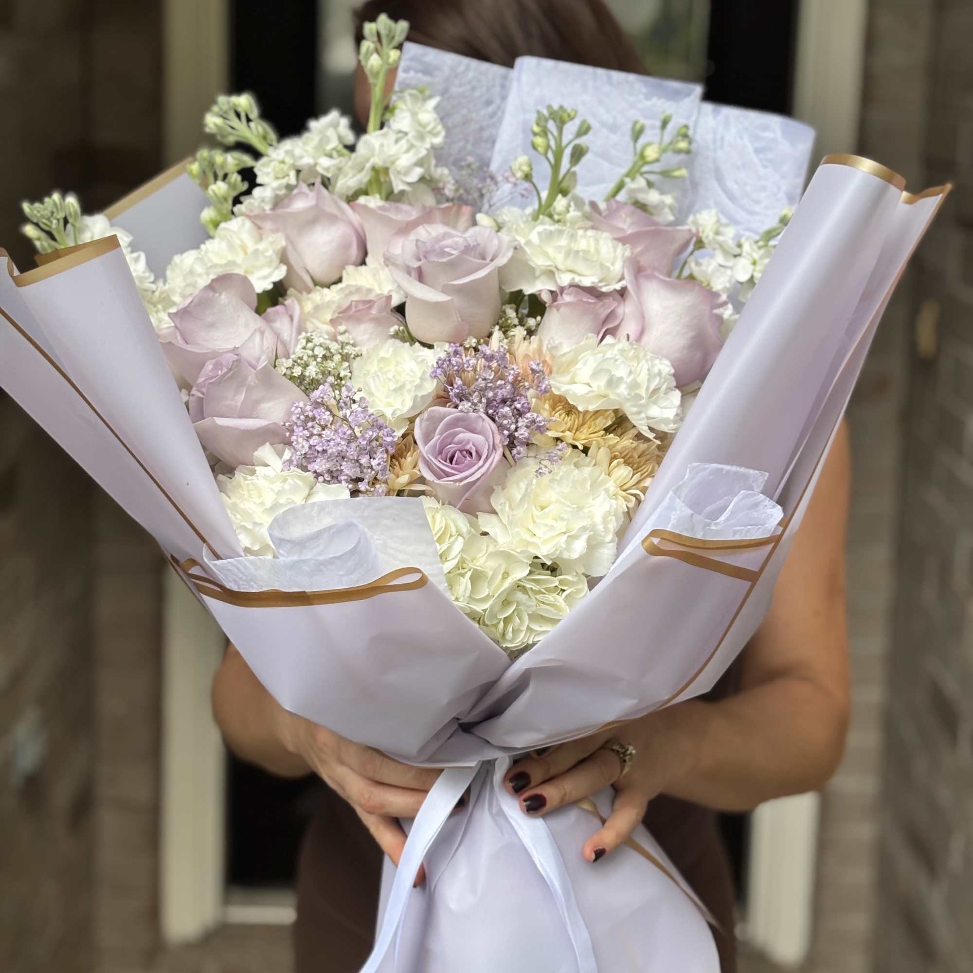 Pale pink roses set the tone in this romantic hand-tied bouquet, a