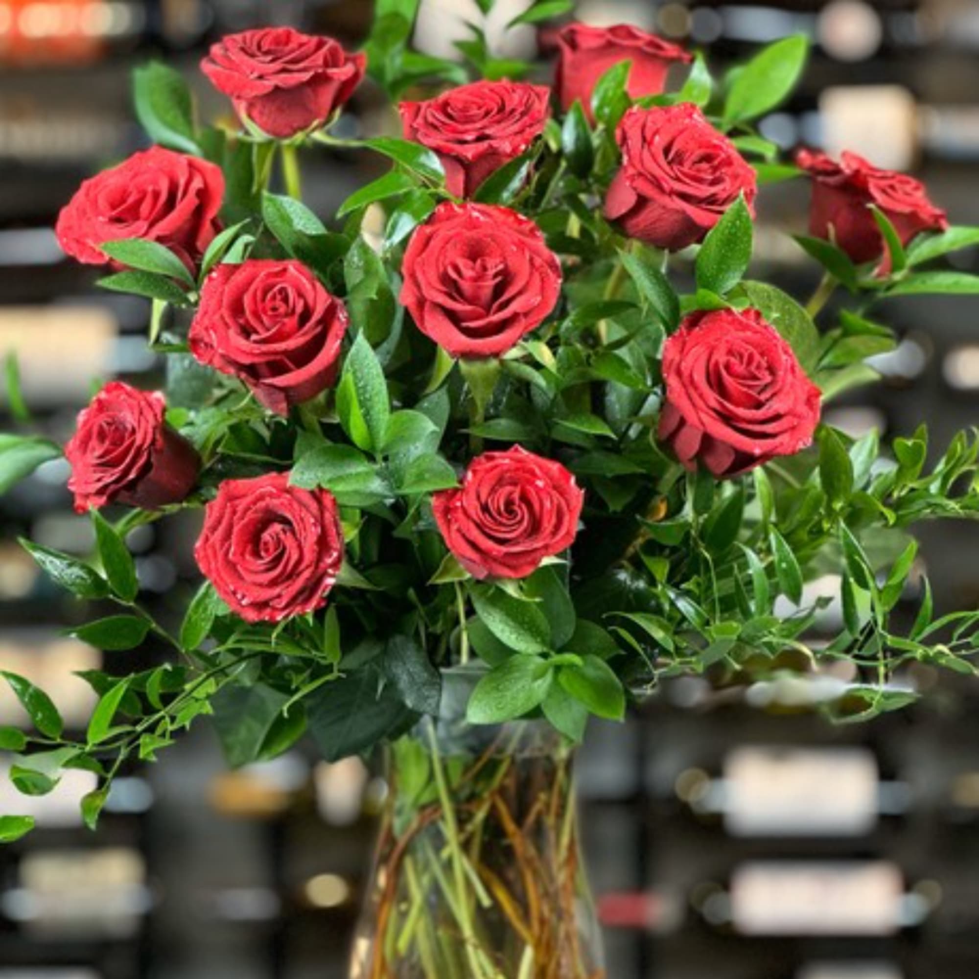 Red roses arranged in a clear glass vase