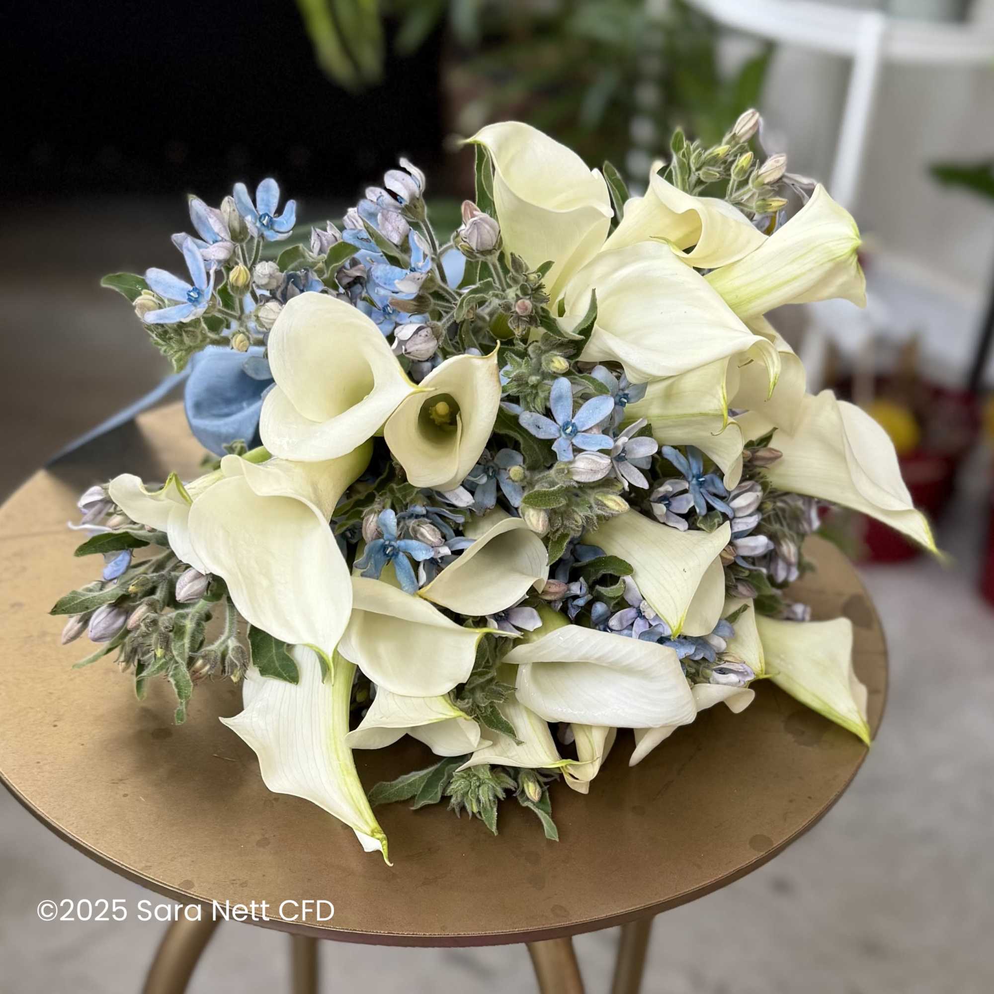Bouquet of white calla lilies and small blue flowers, photo 3 of 4