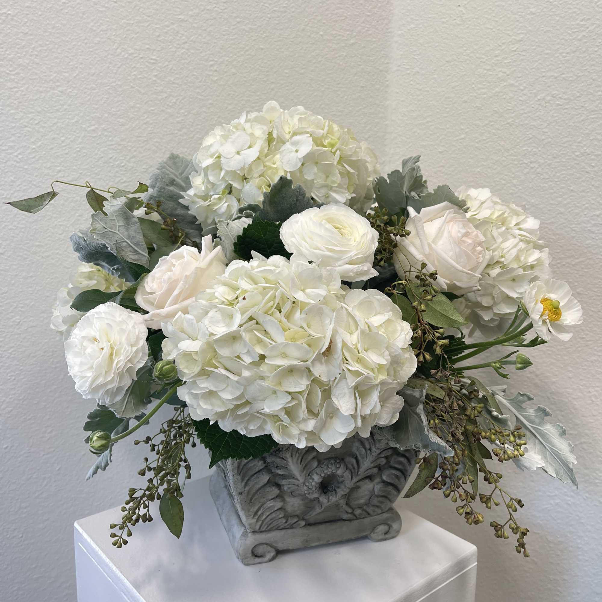 A substantial arrangement of white and cream Flowers set with local greenery, photo 2 of 2