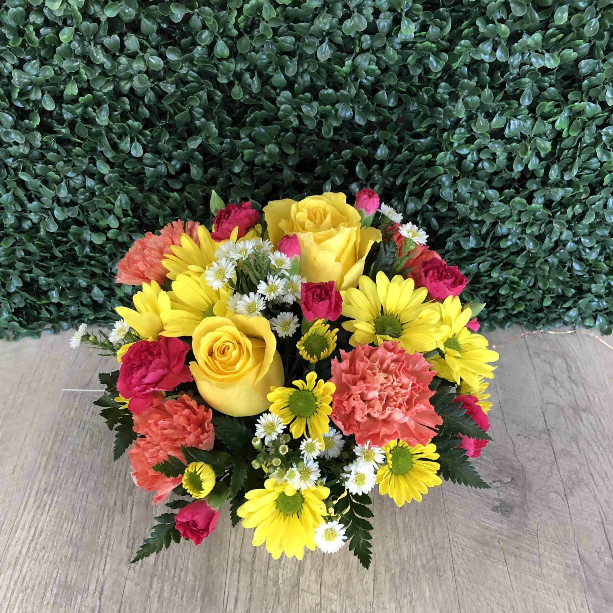 Bright mixed bouquet with yellow roses, daisies, and pink carnations
