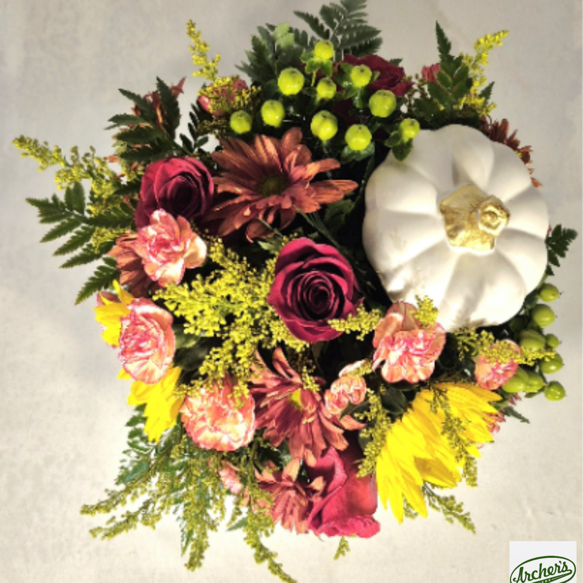 Mixed bouquet with roses, daisies, and a white pumpkin accent