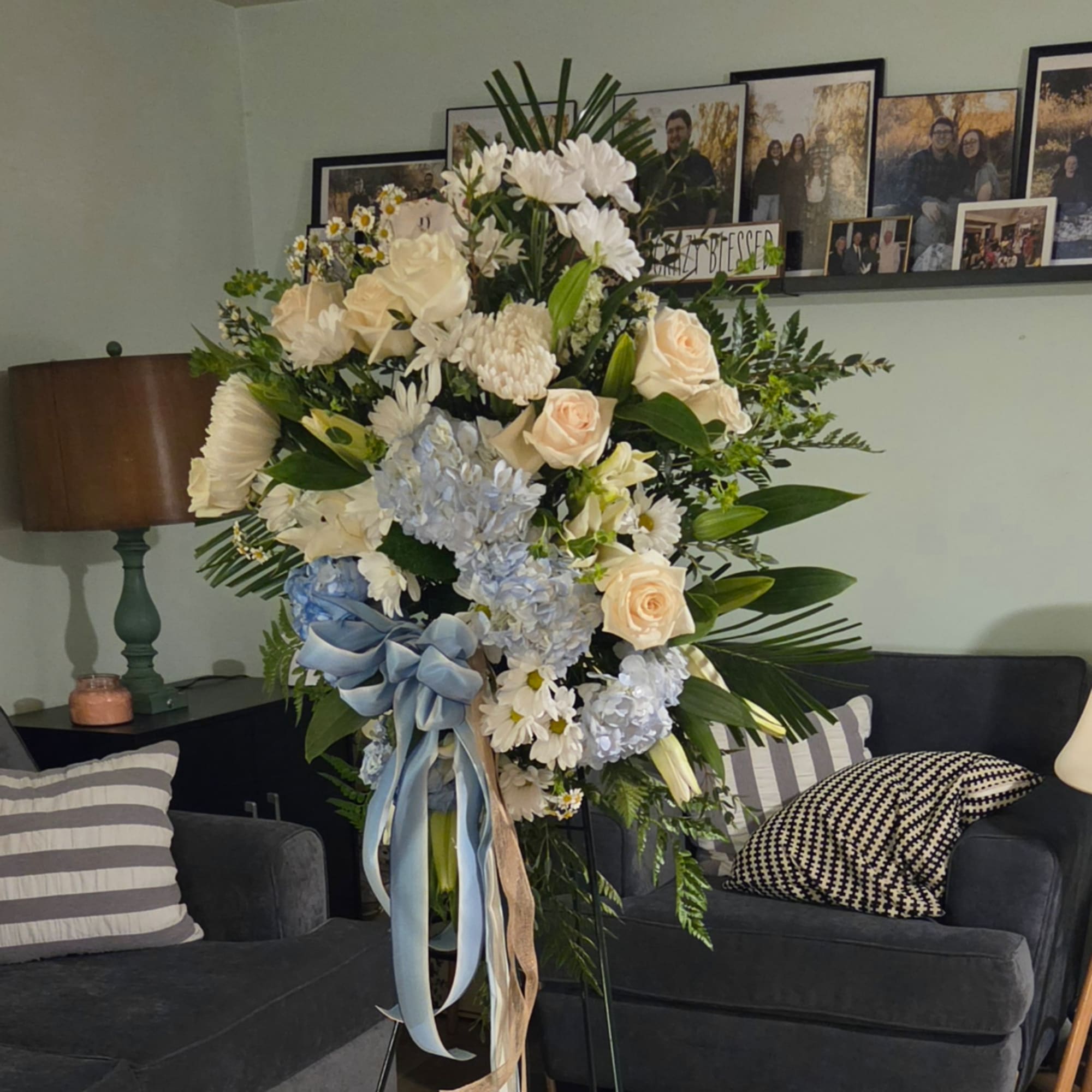 Large pastel floral standing arrangement with roses, hydrangeas, and daisies
