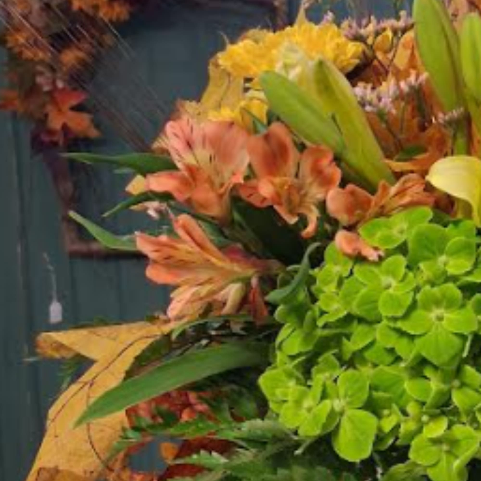 Orange alstroemeria and yellow chrysanthemums with bright green hydrangea