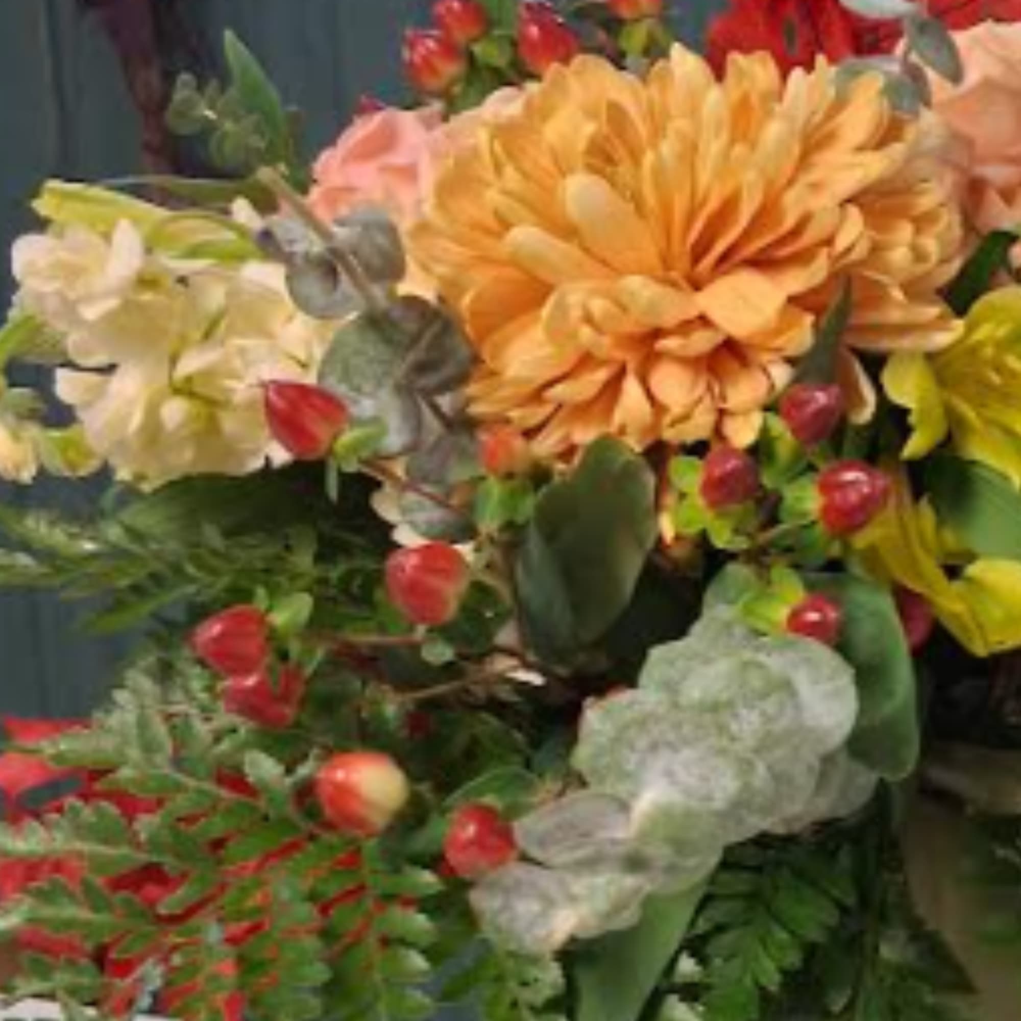 Mixed bouquet with orange and cream flowers and red berries