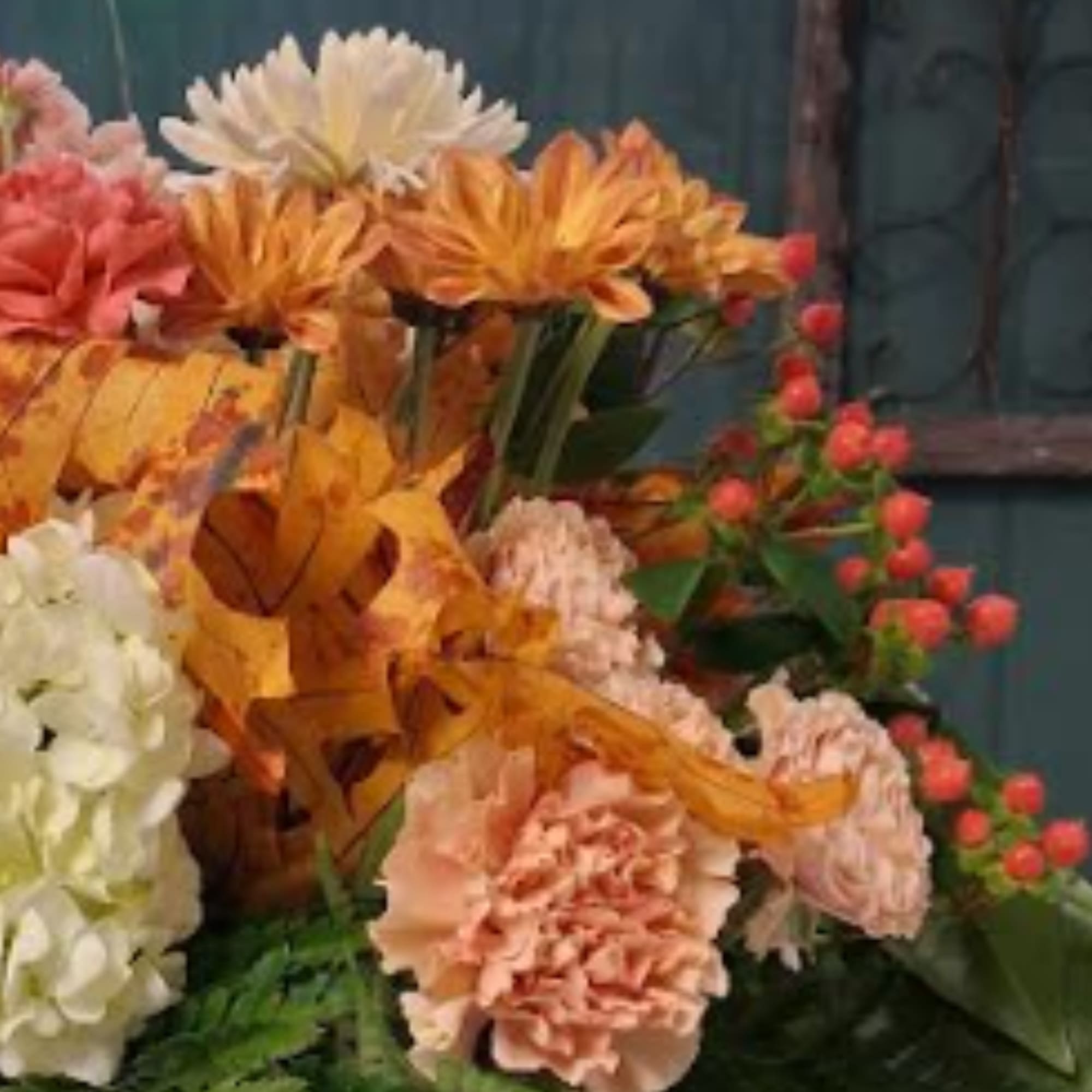 Autumn bouquet with orange and pink flowers and white blooms