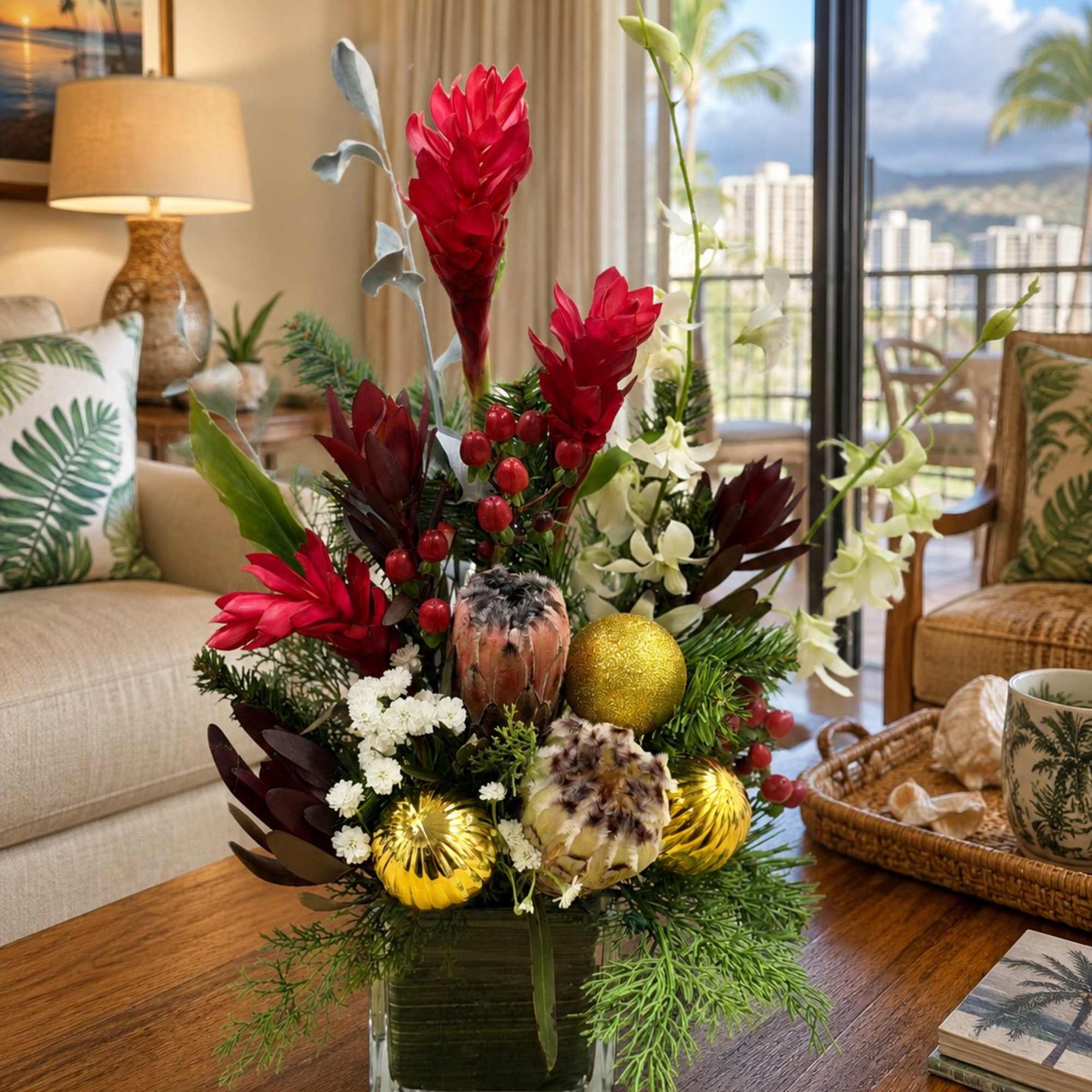 Tropical floral arrangement in a square glass vase with red and white blooms