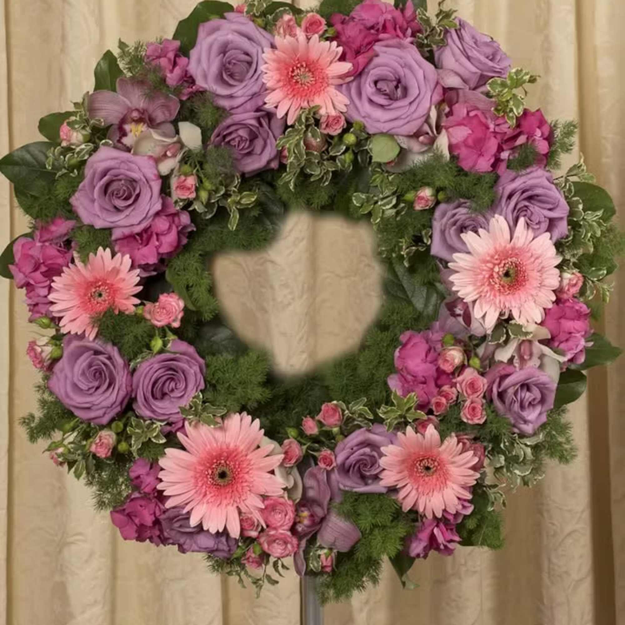 Heart-shaped floral wreath with pink and lavender flowers