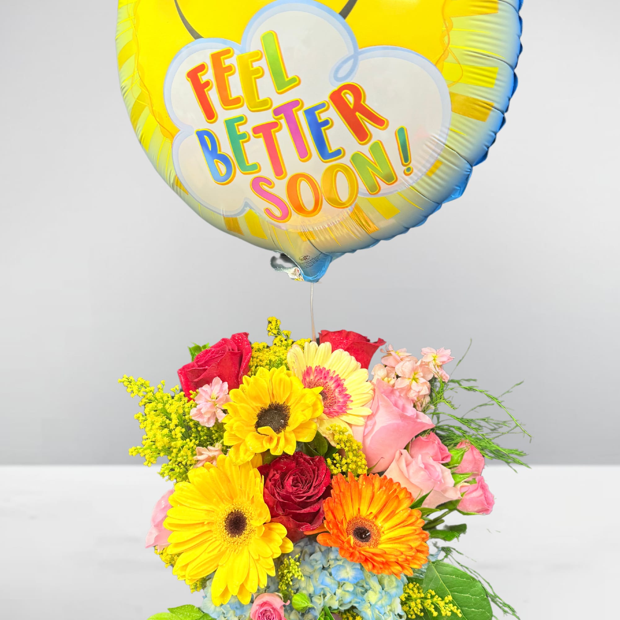 Bouquet with a "Feel Better Soon" balloon and bright mixed flowers