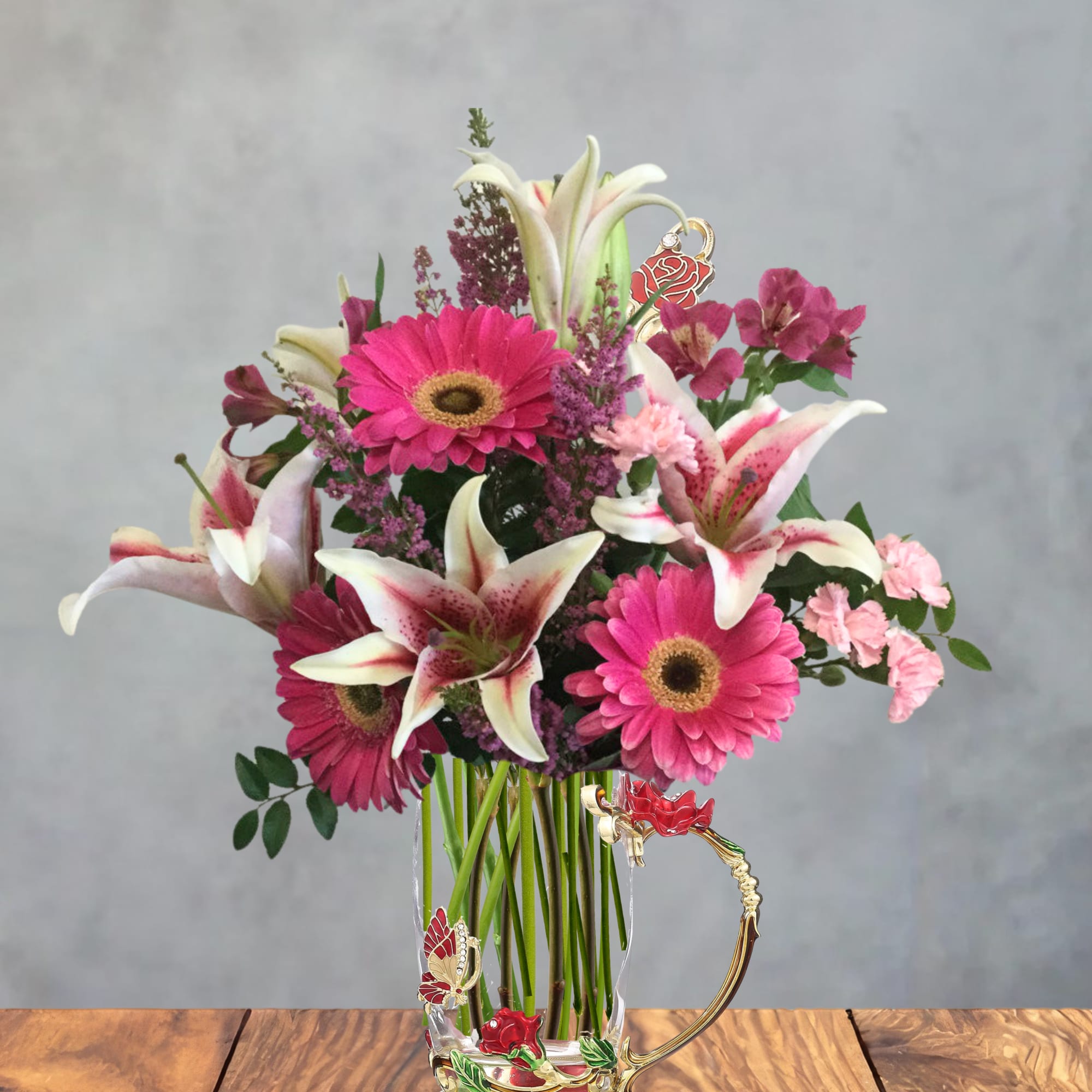 Bright pink gerbera daisies and white-and-pink lilies set the tone in this