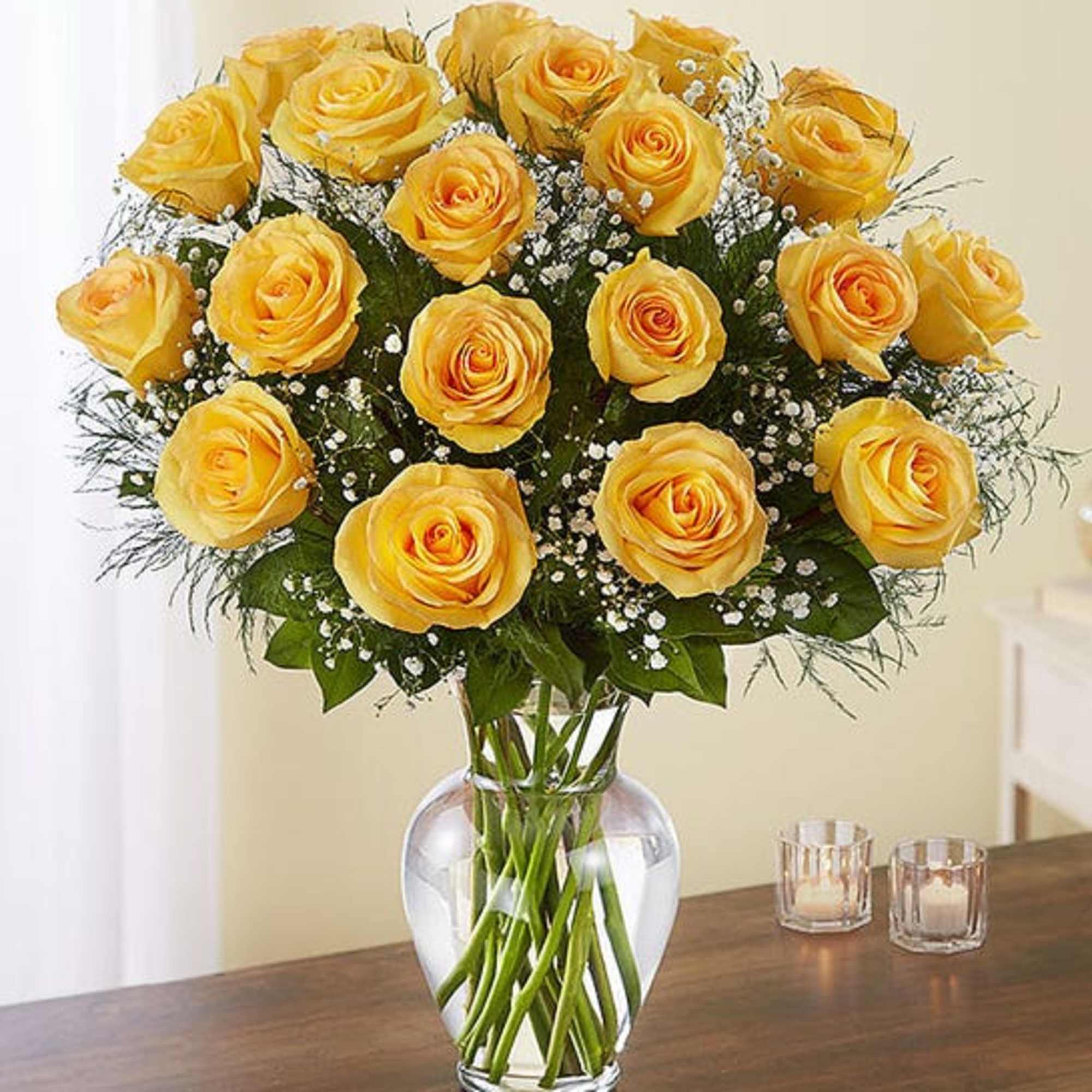 Yellow roses arranged in a clear glass vase