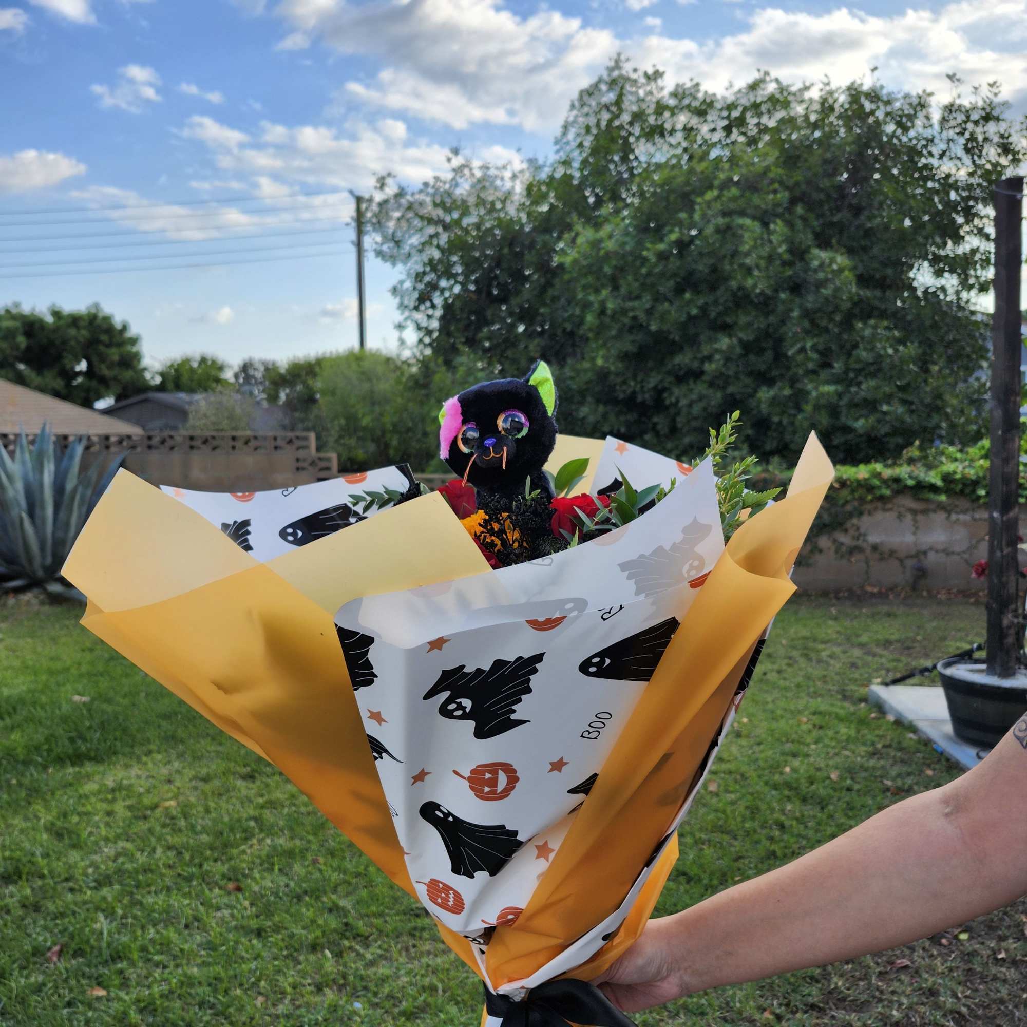 Designer's Choice with roses and Marigolds Halloween theme paper wrapped bouquet 