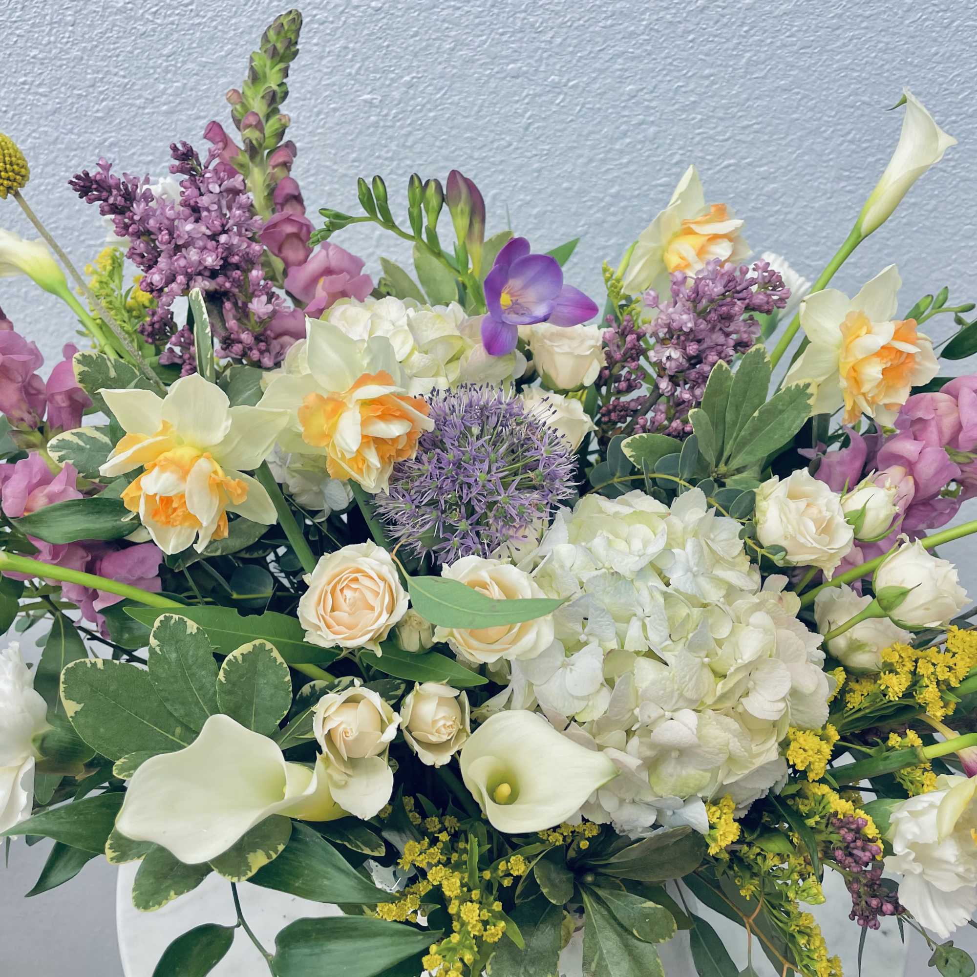 Mixed bouquet with white calla lilies, hydrangea, and purple flowers