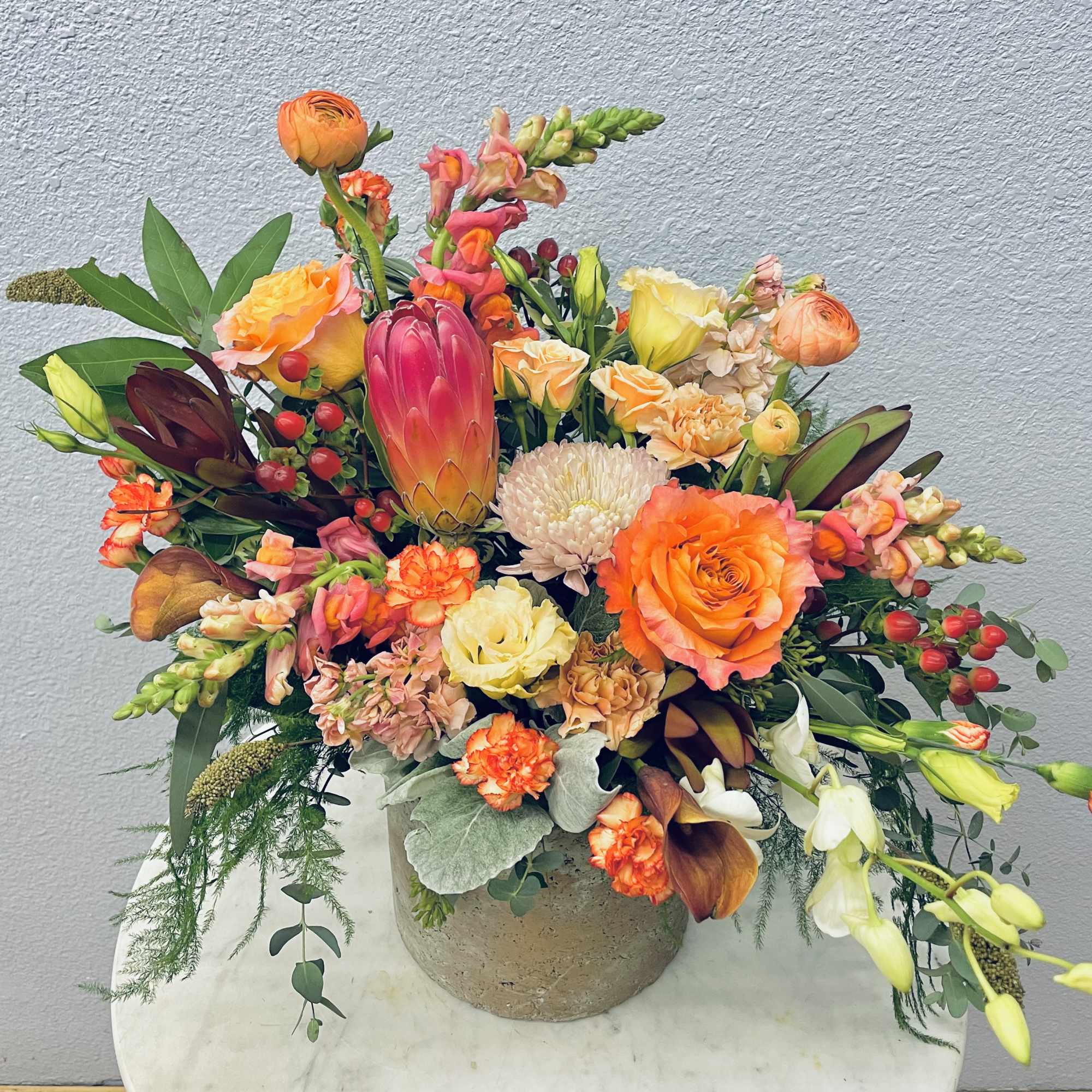 Colorful mixed flower arrangement in a round vase