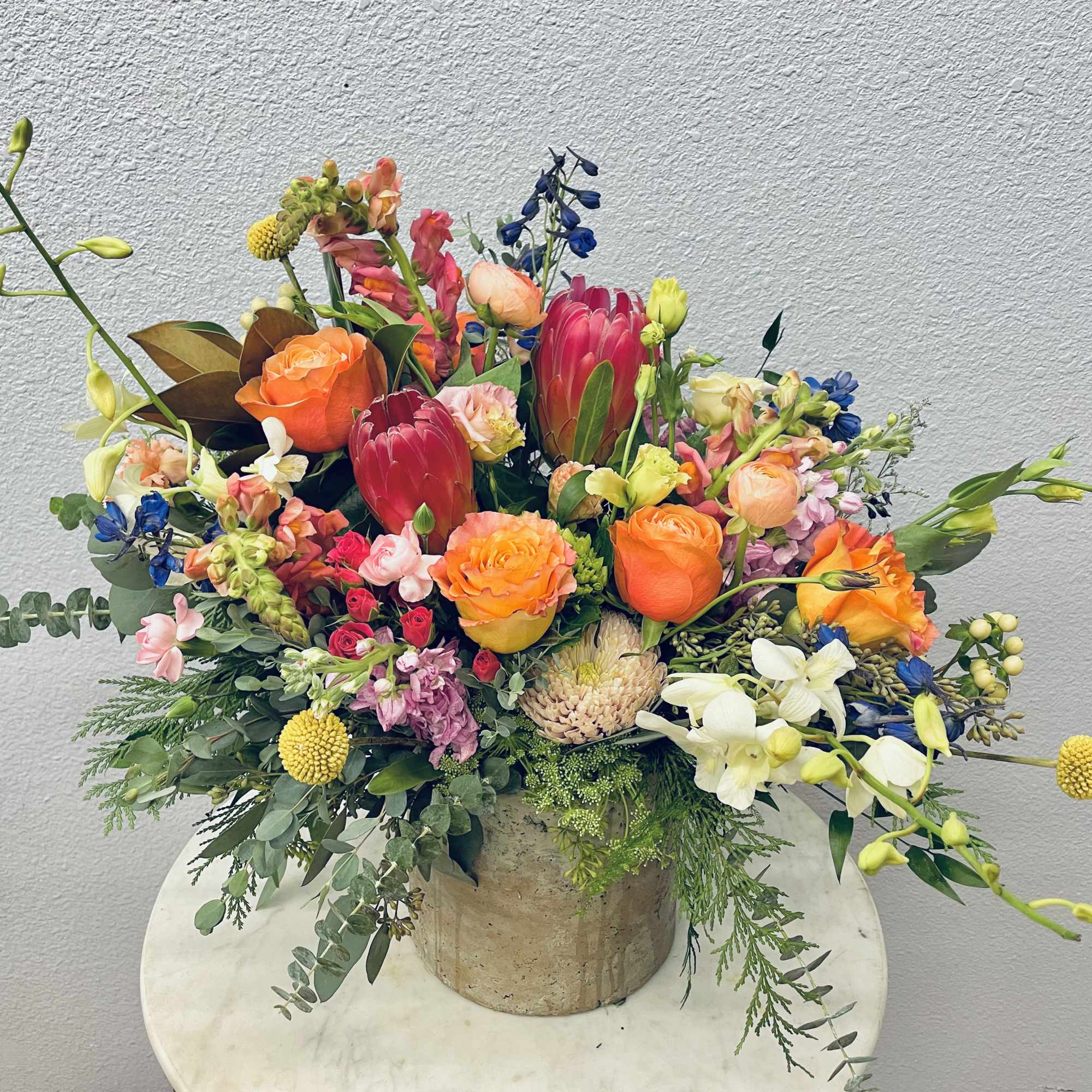 Colorful mixed bouquet in a rustic container