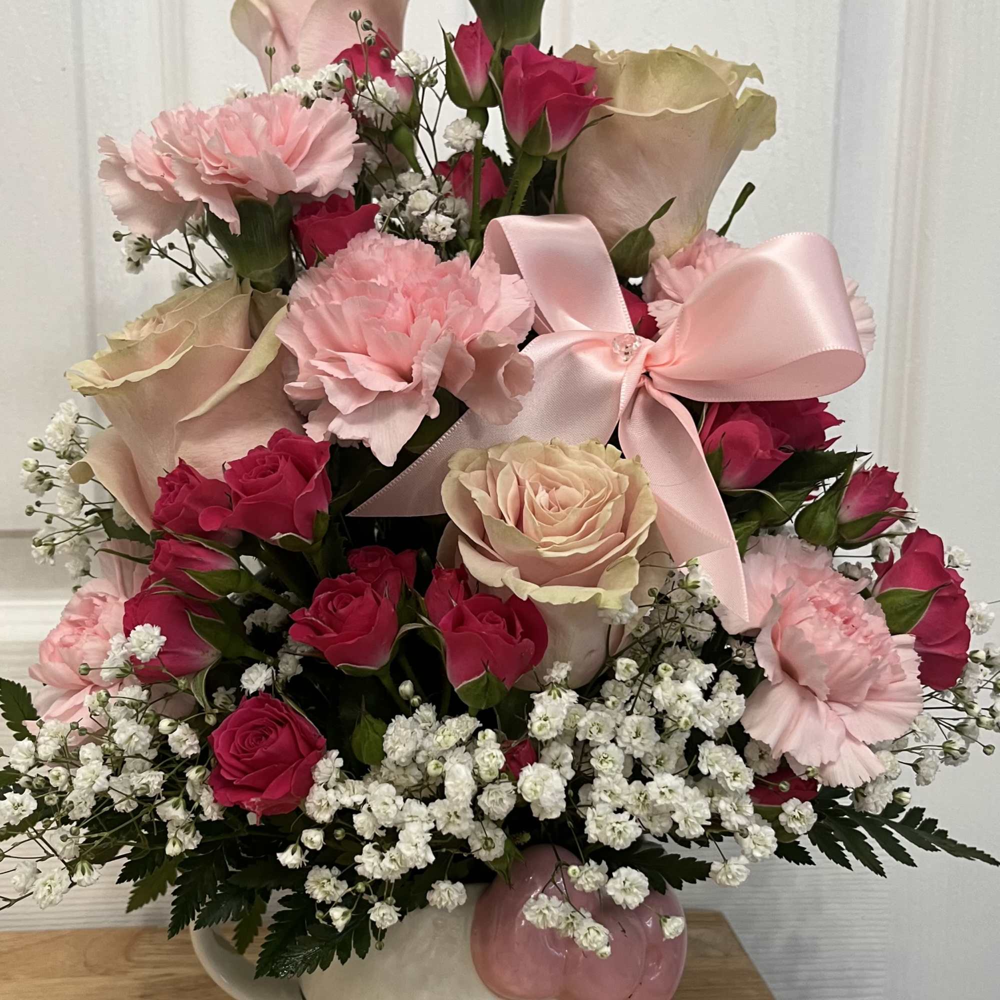 Pink and cream rose bouquet in a Hello Kitty vase with a satin bow