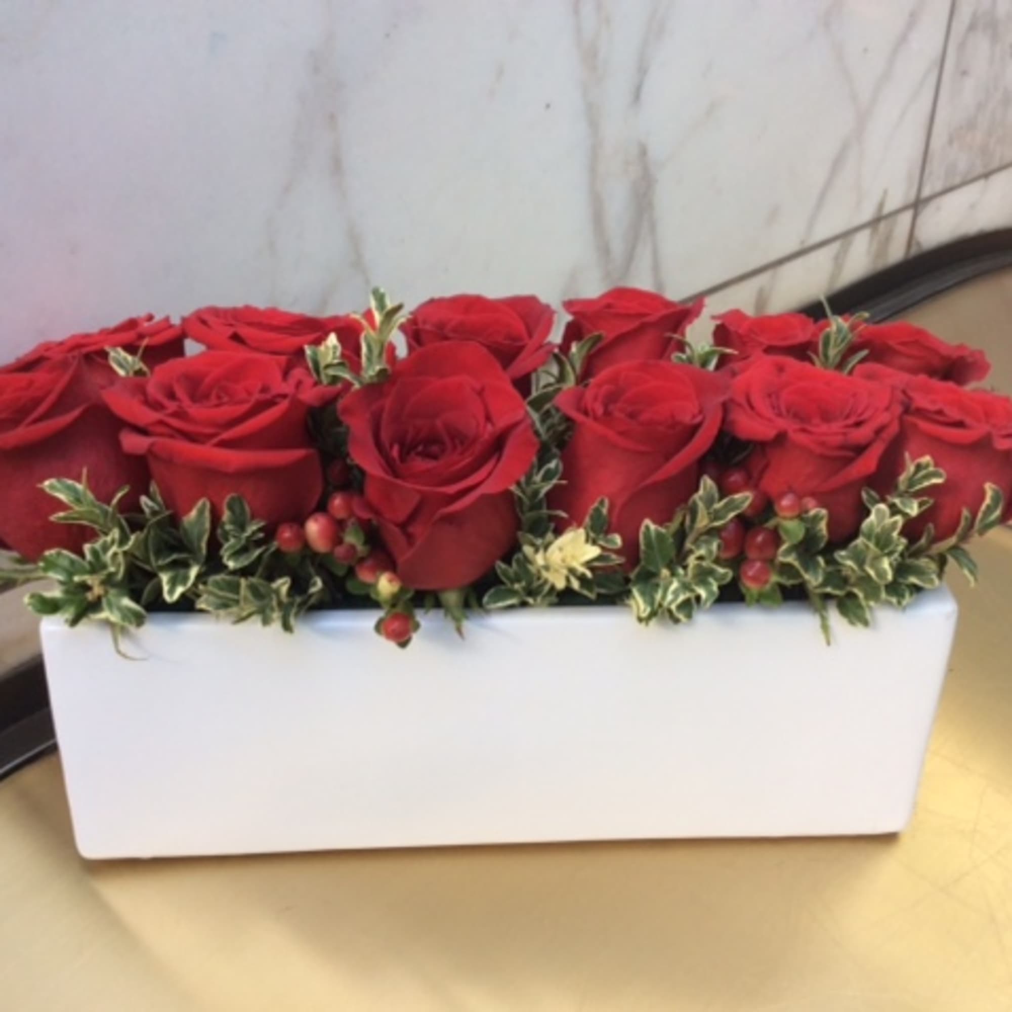 Red roses arranged in a white rectangular box
