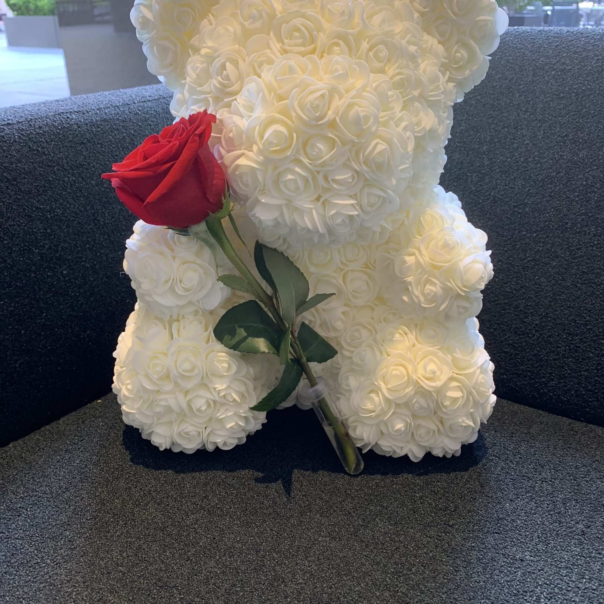 White rose teddy bear holding a red rose