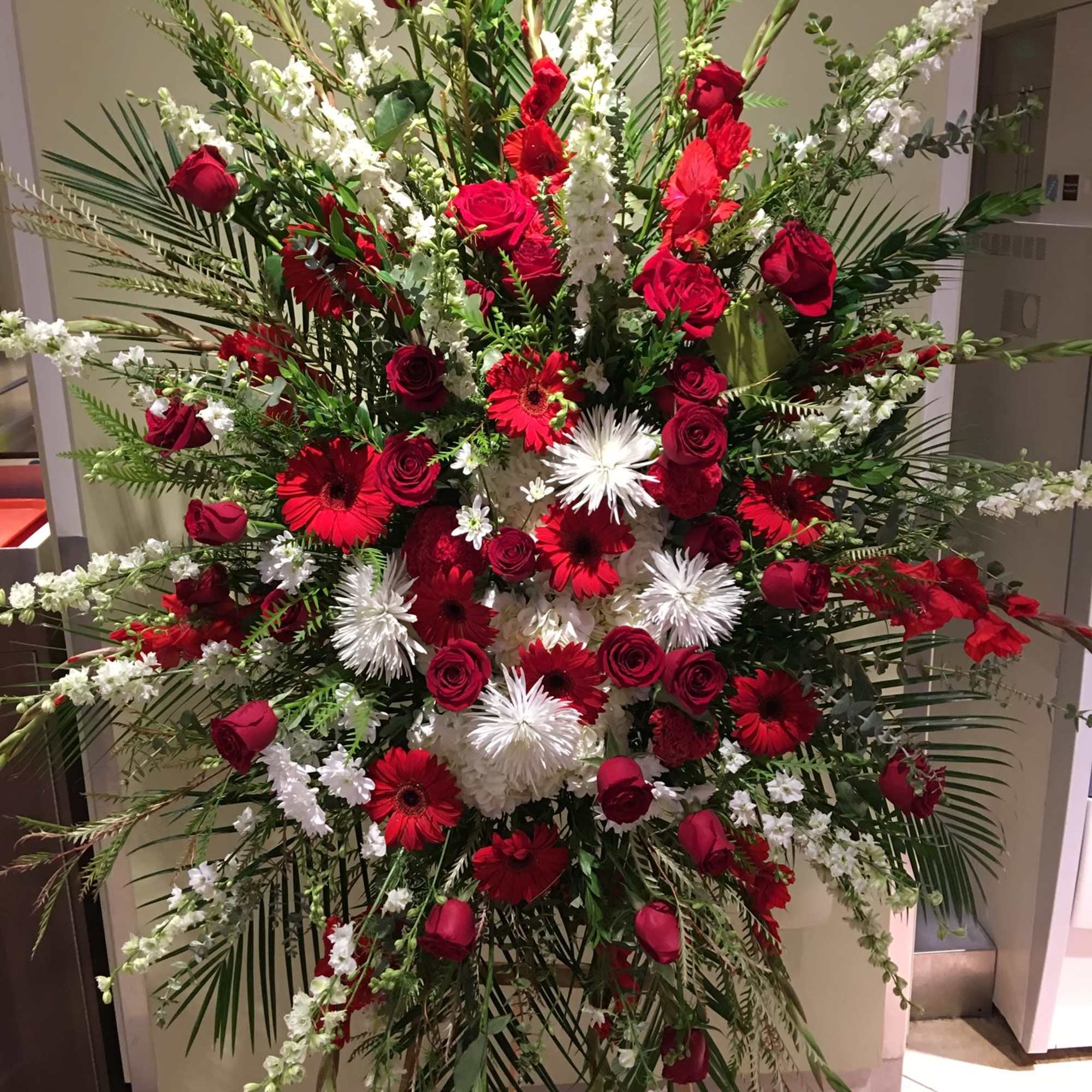 Large standing floral spray with red roses and white flowers