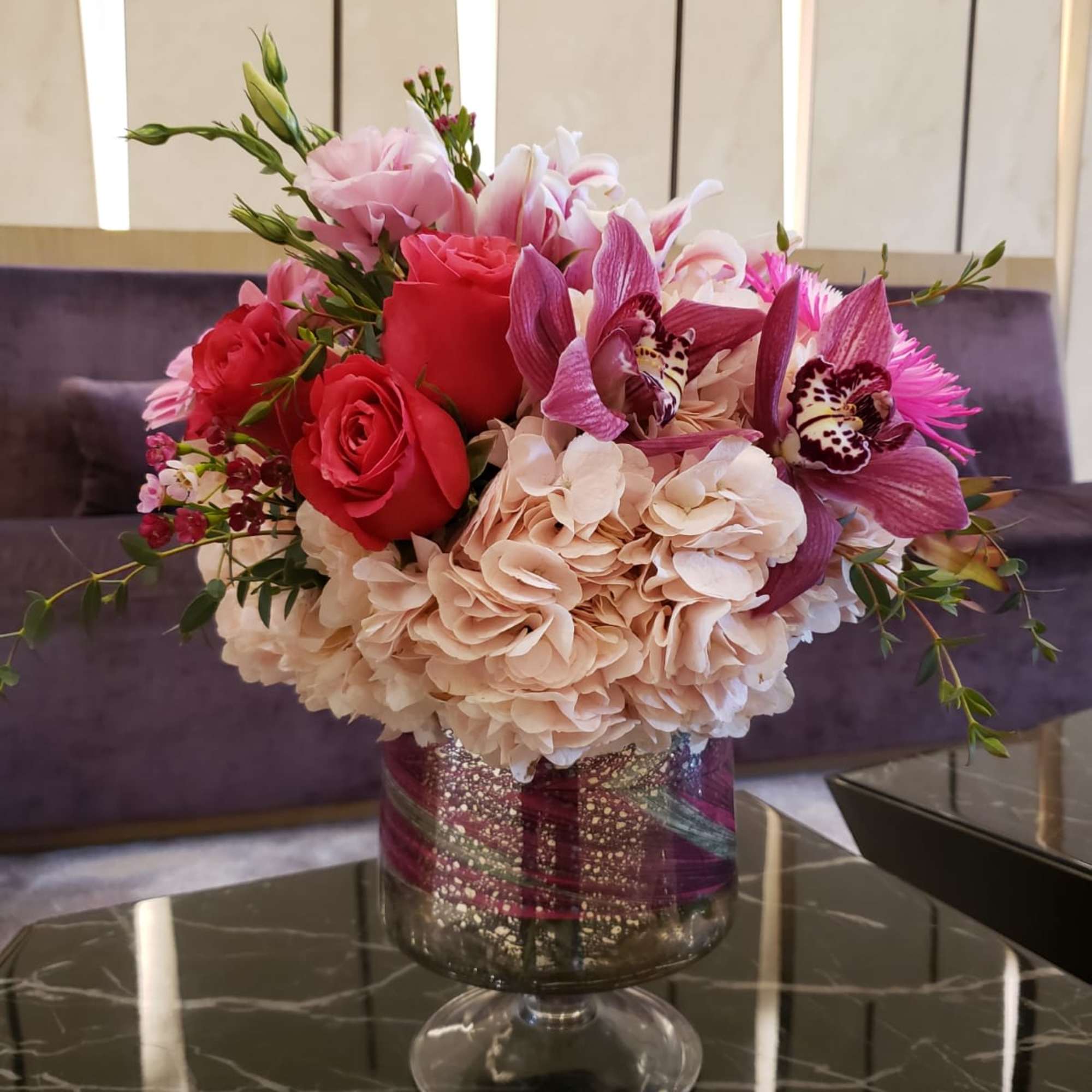 Bouquet of pink and red flowers in a glass vase
