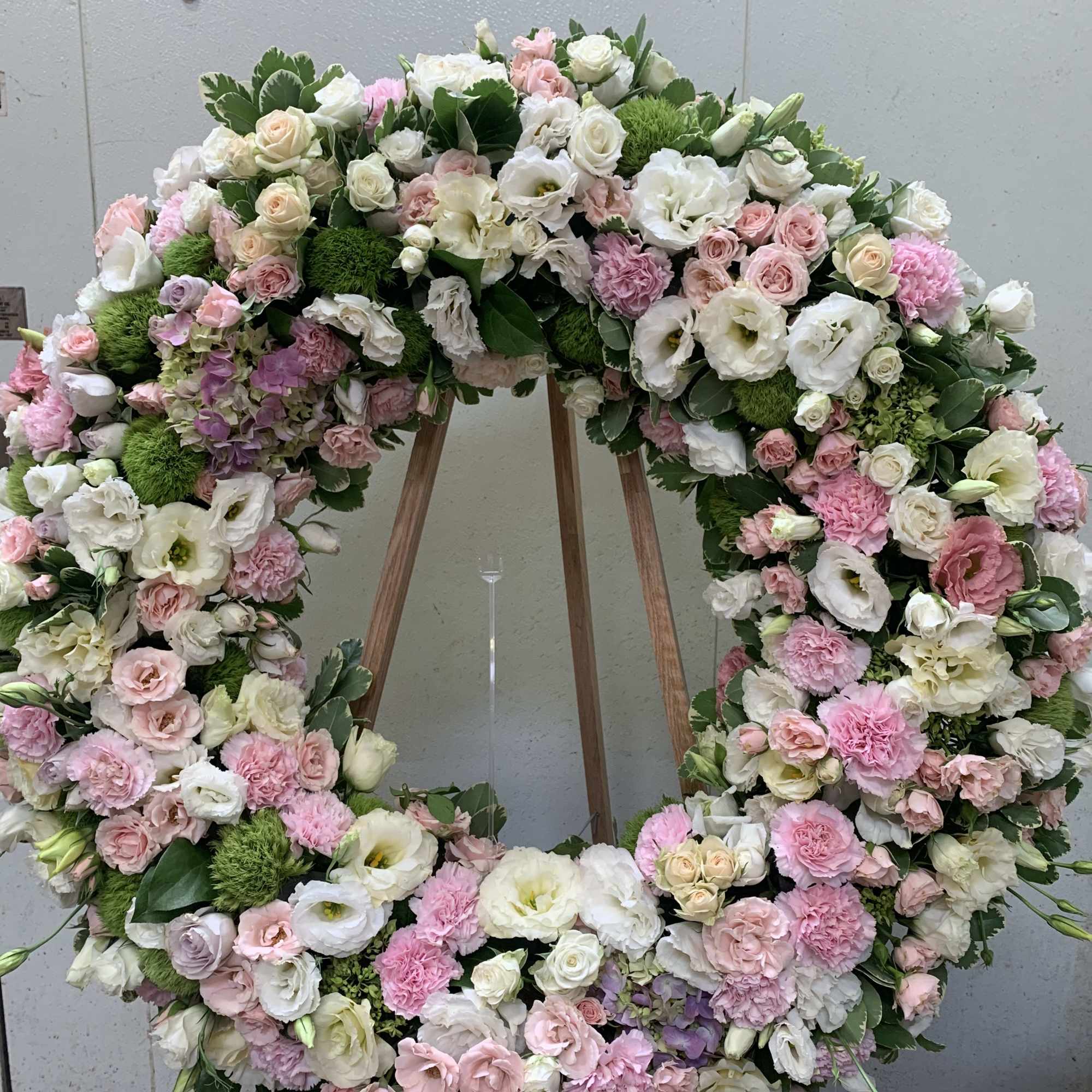 Large pastel floral wreath on a wooden easel, photo 2 of 3