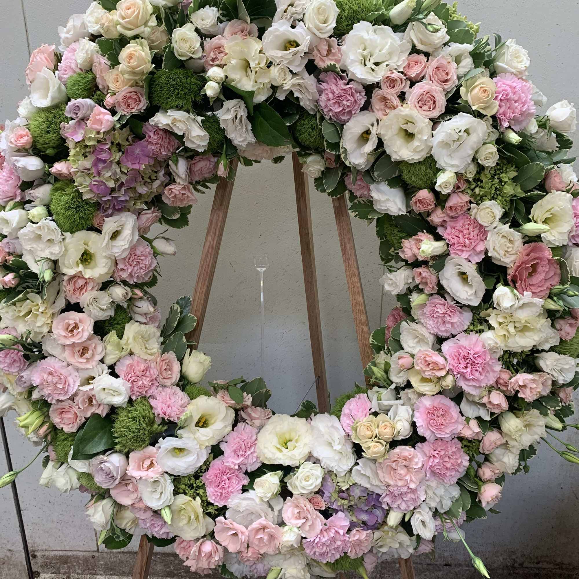 Large pastel floral wreath on a wooden easel, photo 3 of 3