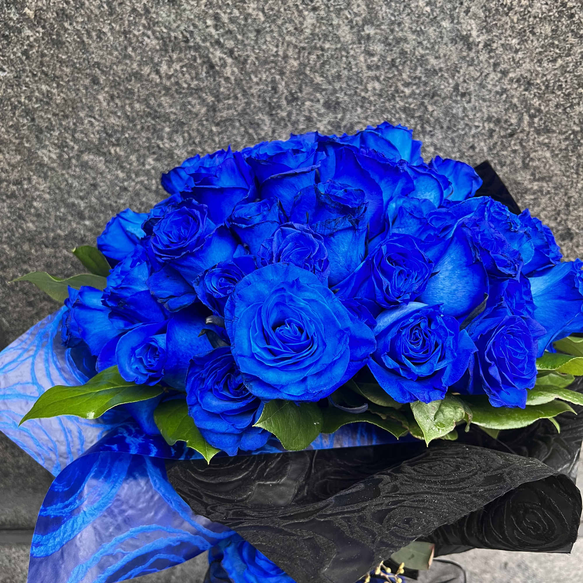 Bouquet of vivid blue roses wrapped in black and blue paper, photo 4 of 5