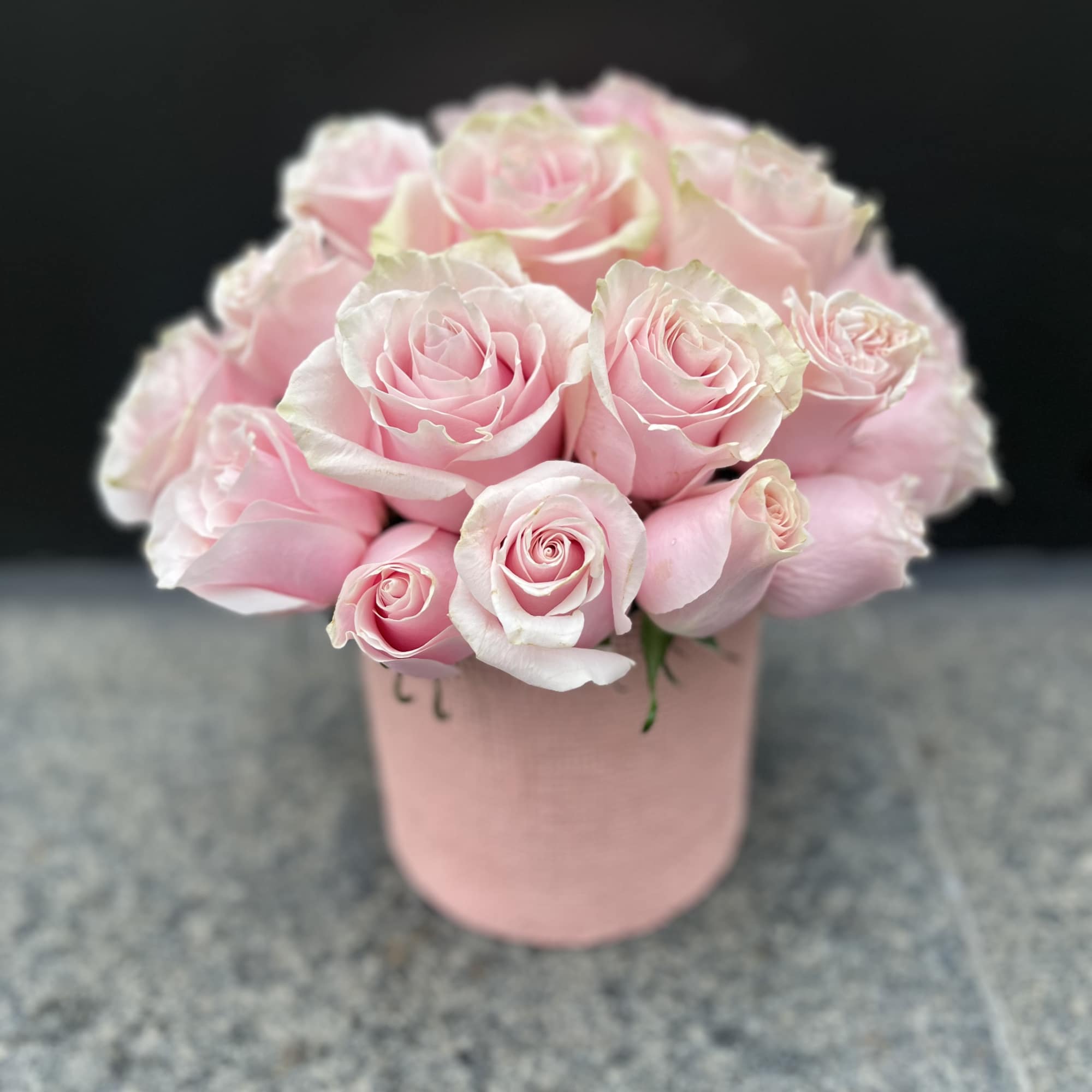 Pink roses arranged in a blush pink box
