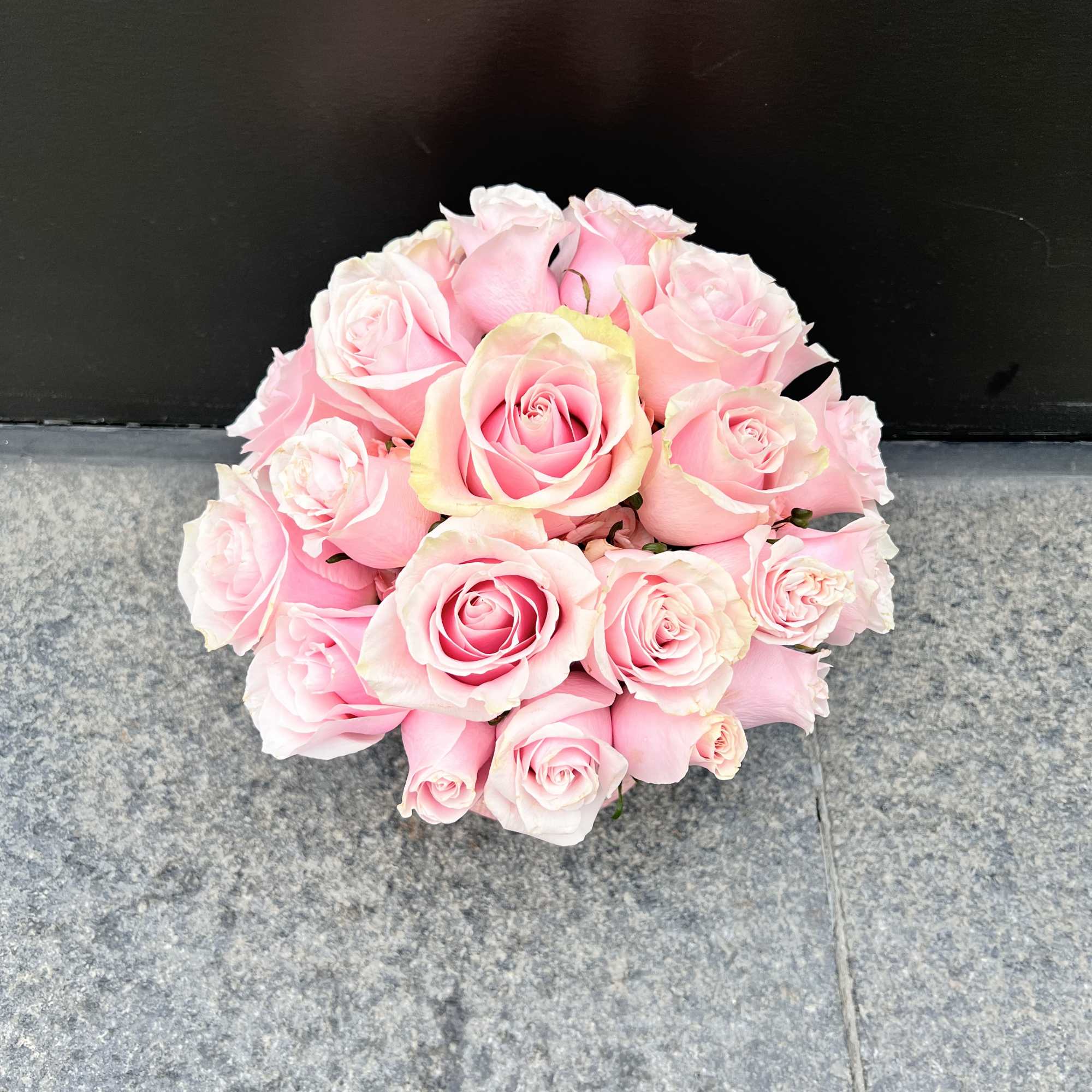 Bouquet of pale pink roses arranged in a round cluster