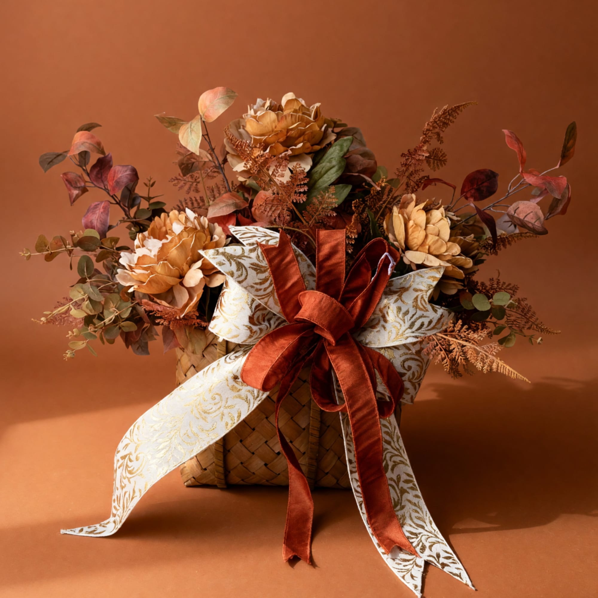 Autumn floral basket with gold flowers and a large ribbon bow