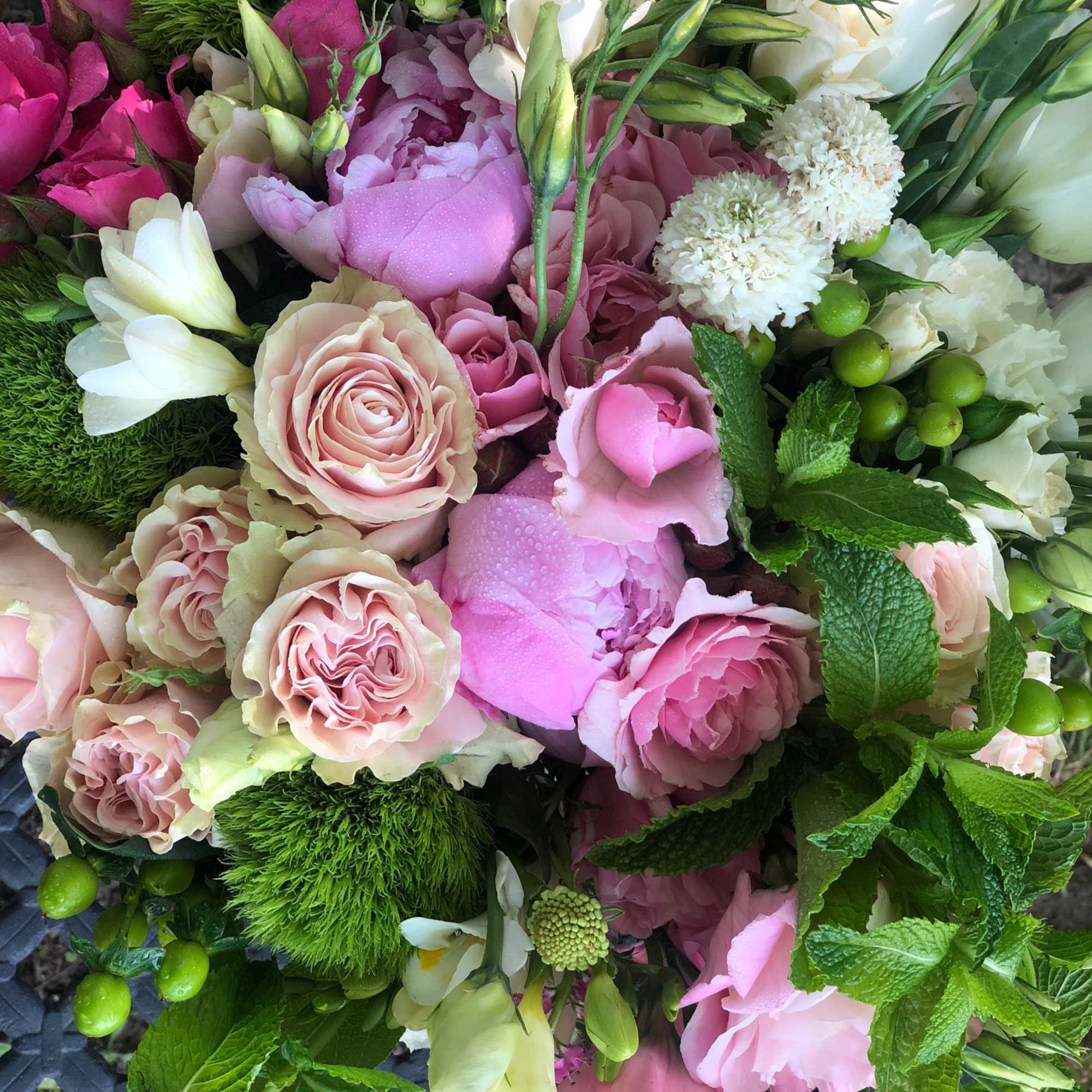 Experience the beauty of lush blooms, including garden roses,  spray roses