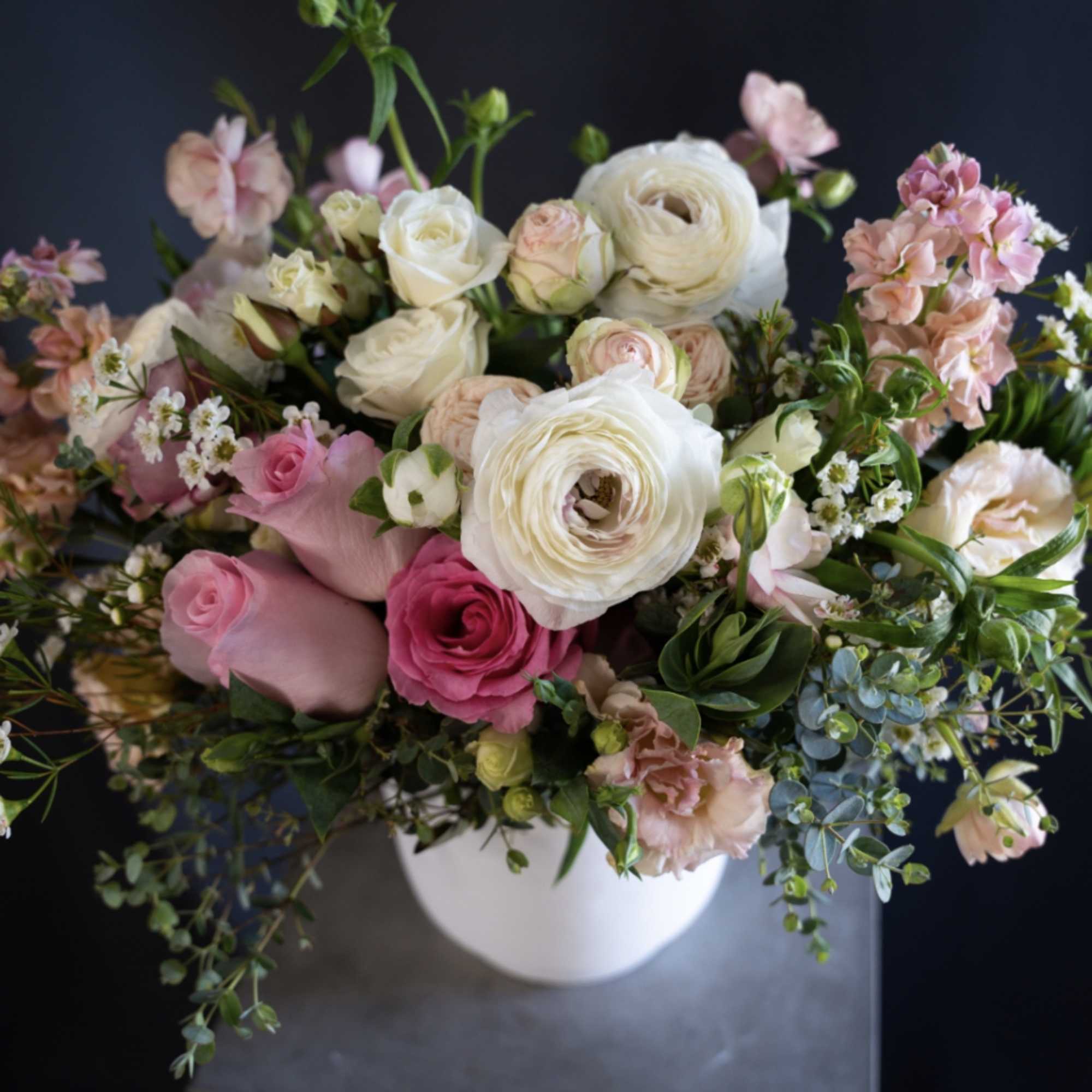 Pink and white mixed bouquet in a white vase