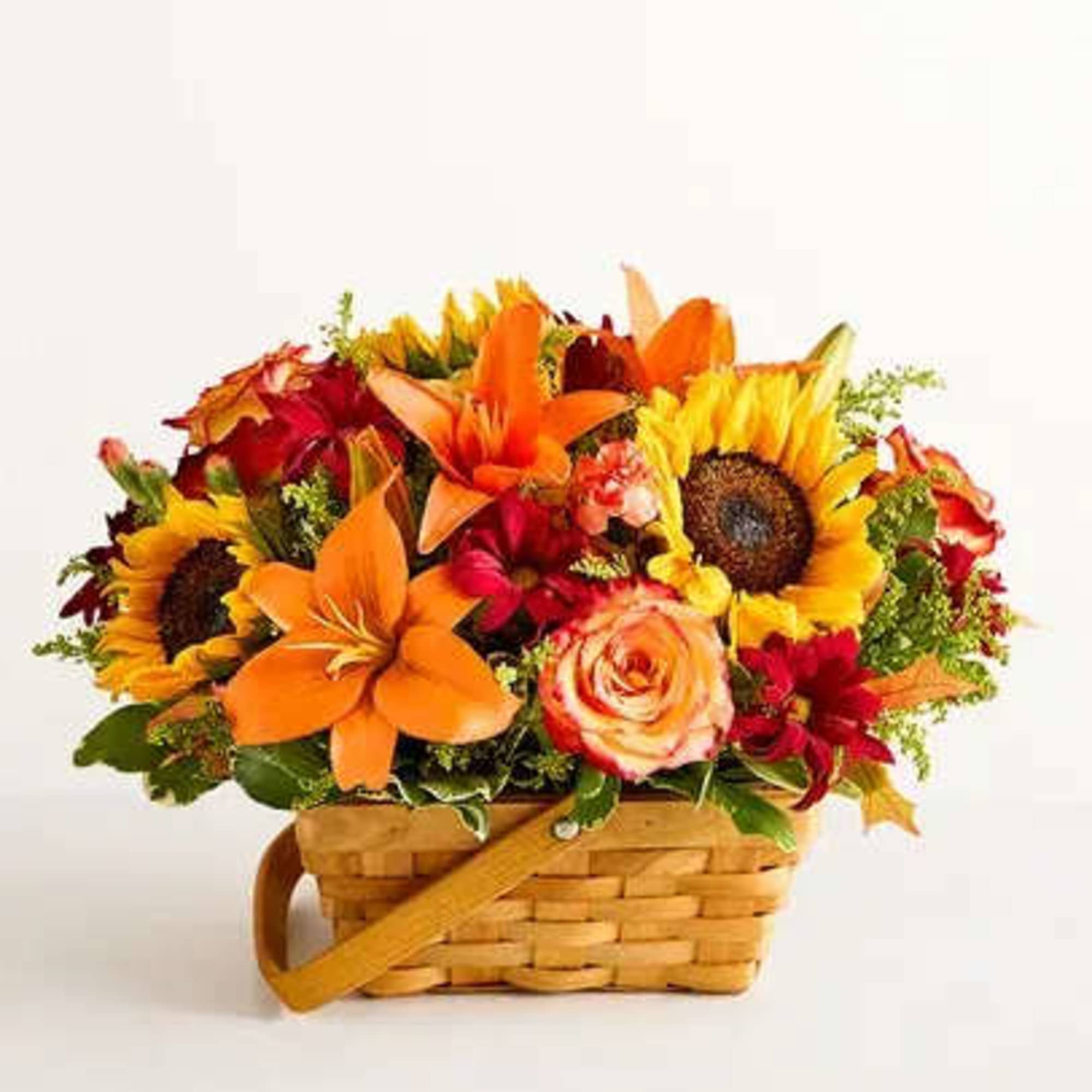 Basket arrangement with sunflowers, orange lilies, and roses