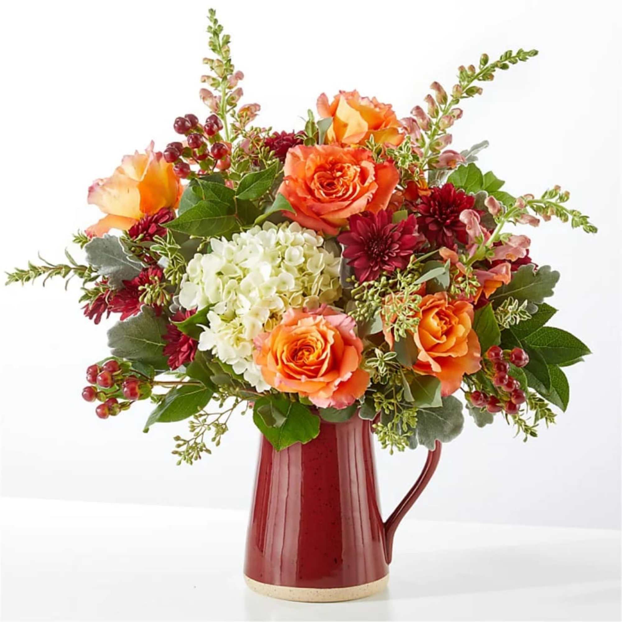 A generous white hydrangea crown anchors this garden-style flower arrangement, surrounded by