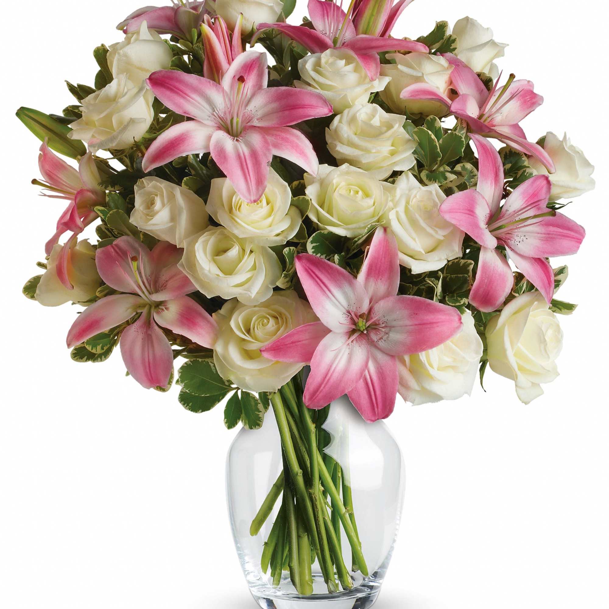 Pink lilies and white roses in a clear glass vase