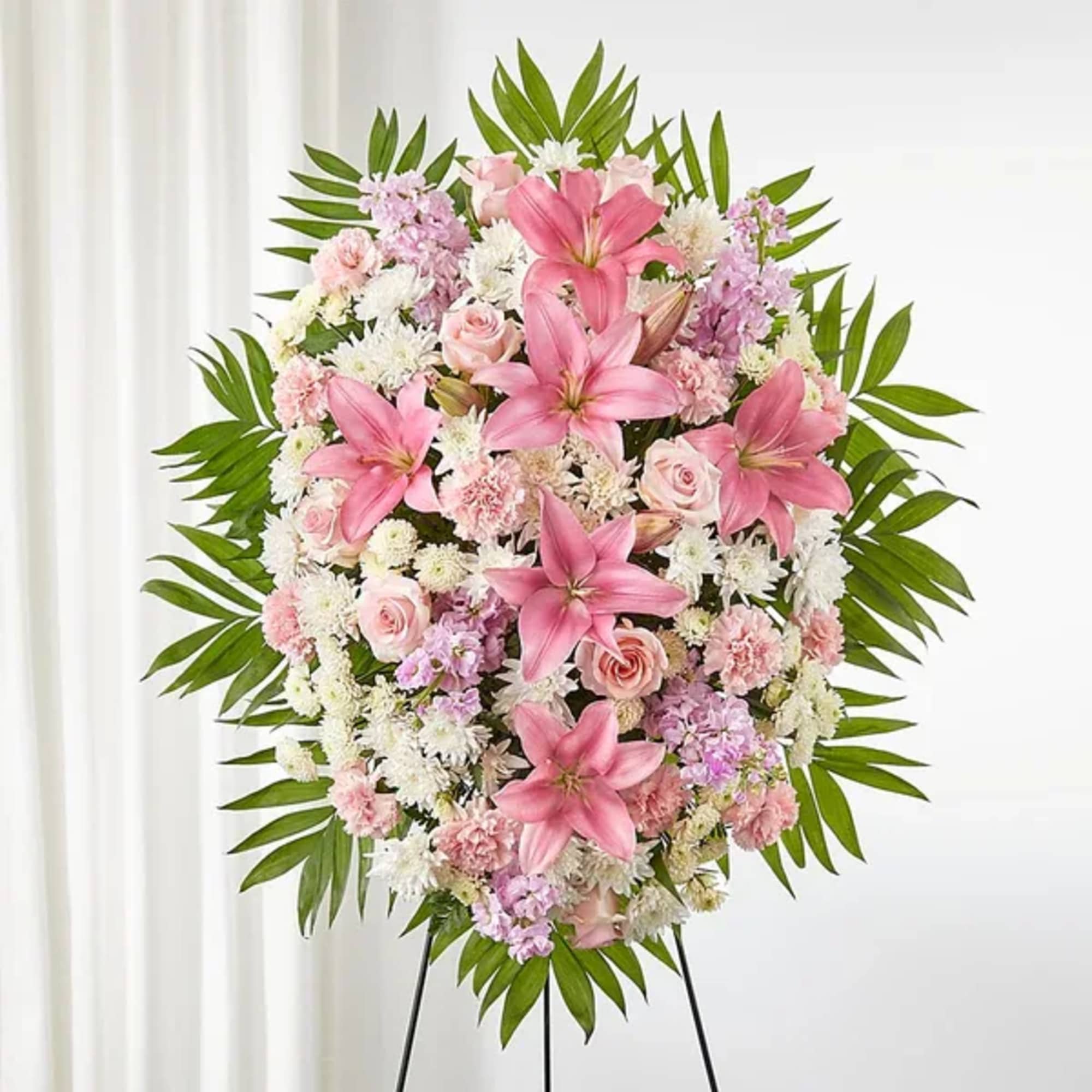Standing floral spray with pink lilies, roses, and white blooms