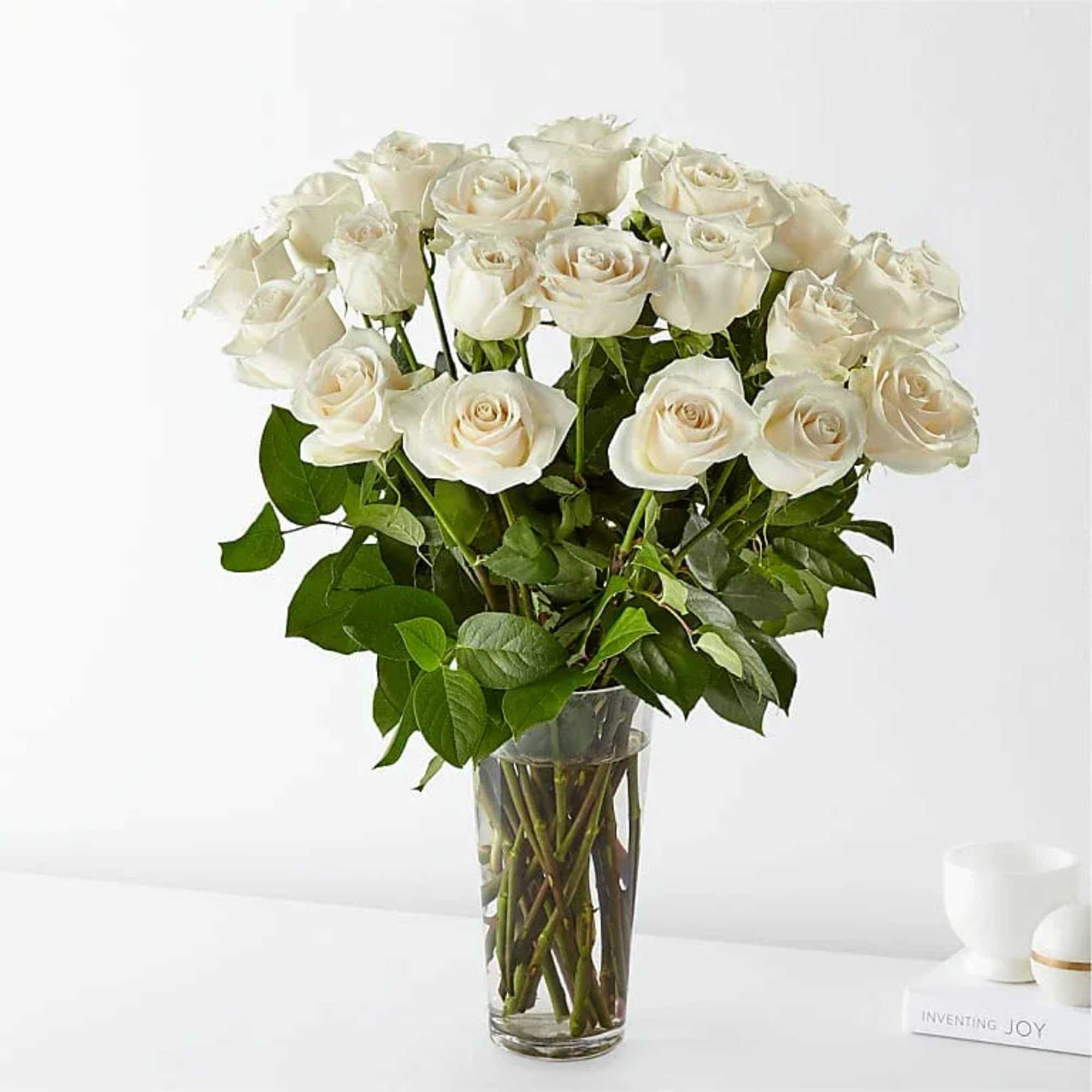 Bouquet of white roses in a clear glass vase