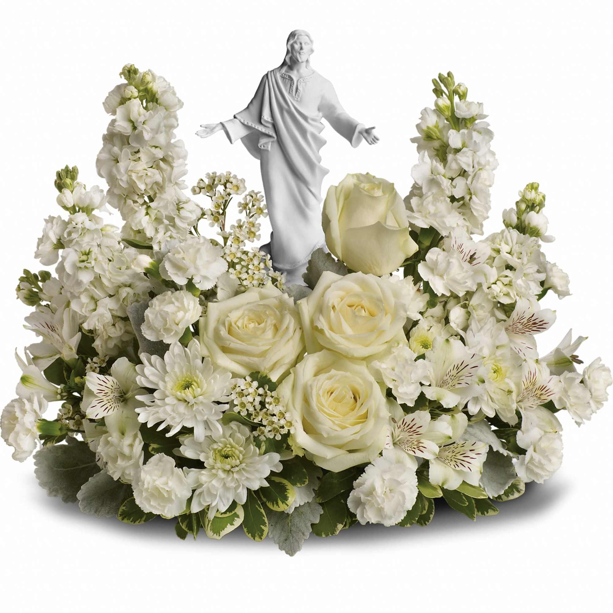 White floral arrangement with a small religious statue in the center