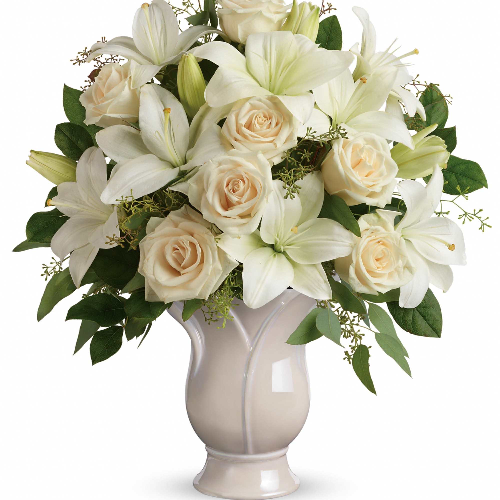 White lilies and cream roses arranged in a beige vase
