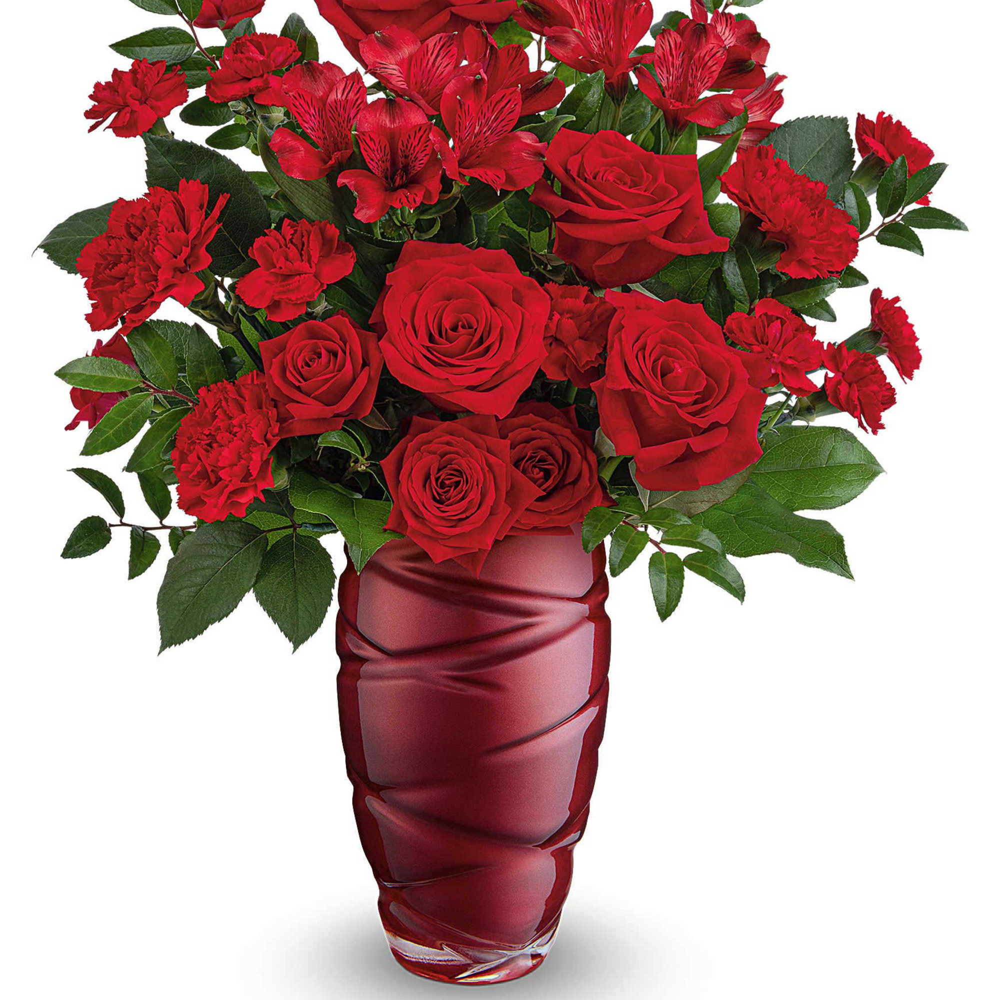 Red roses and carnations in a red glass vase
