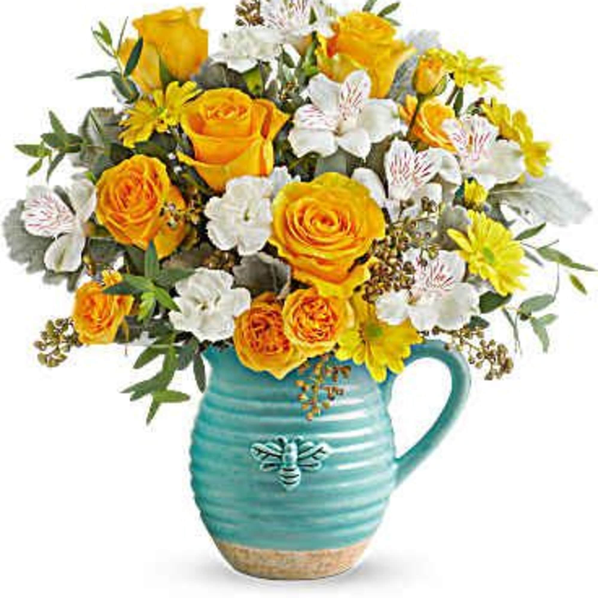 Yellow and white flower bouquet in a turquoise ceramic pitcher