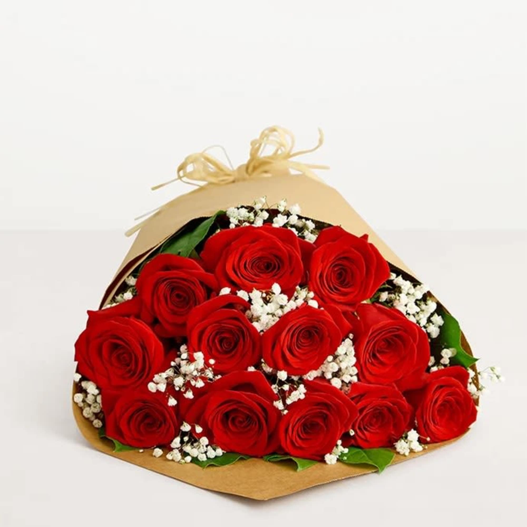 Bouquet of red roses with white baby's breath in brown paper wrap