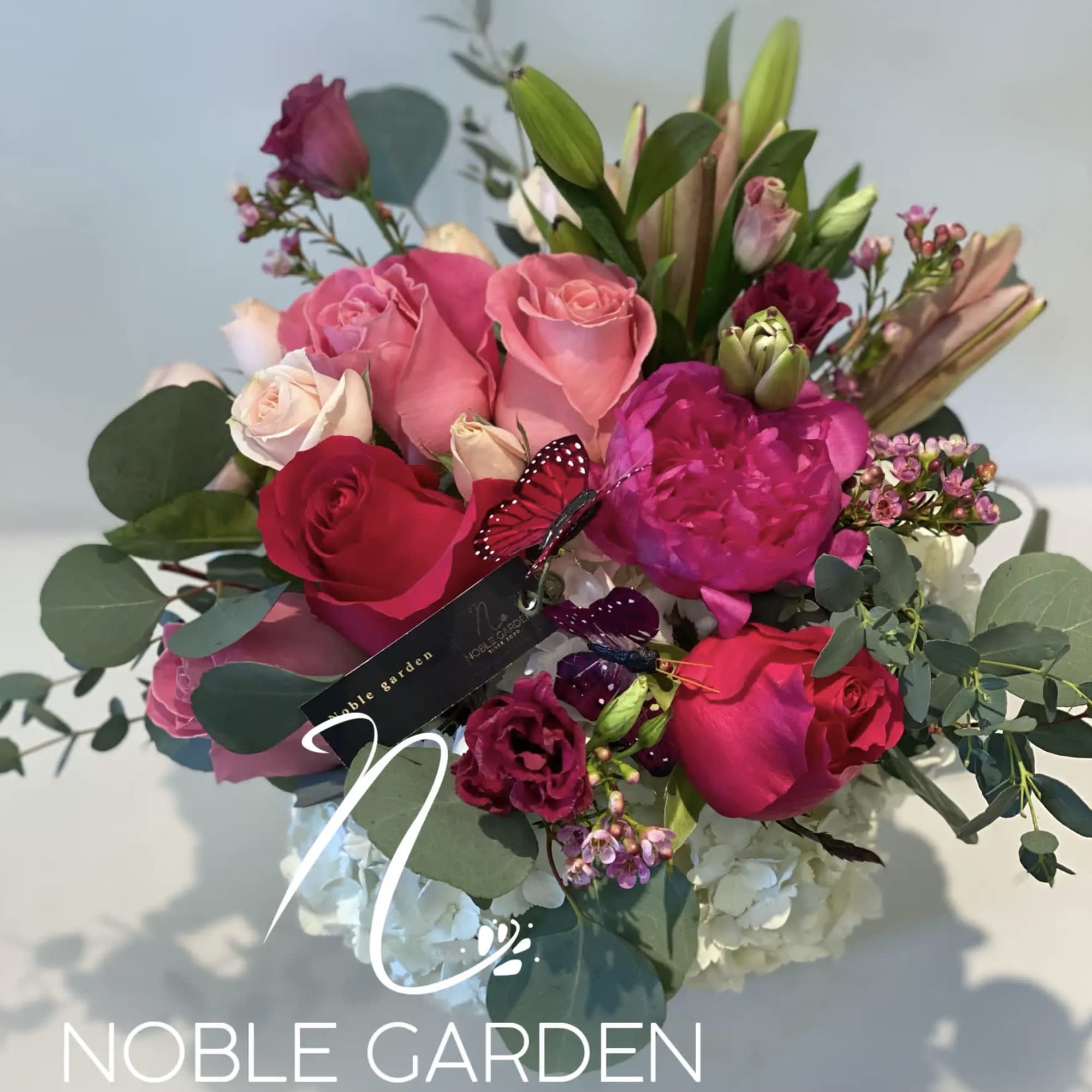 Bouquet of pink and red roses with eucalyptus and lilies