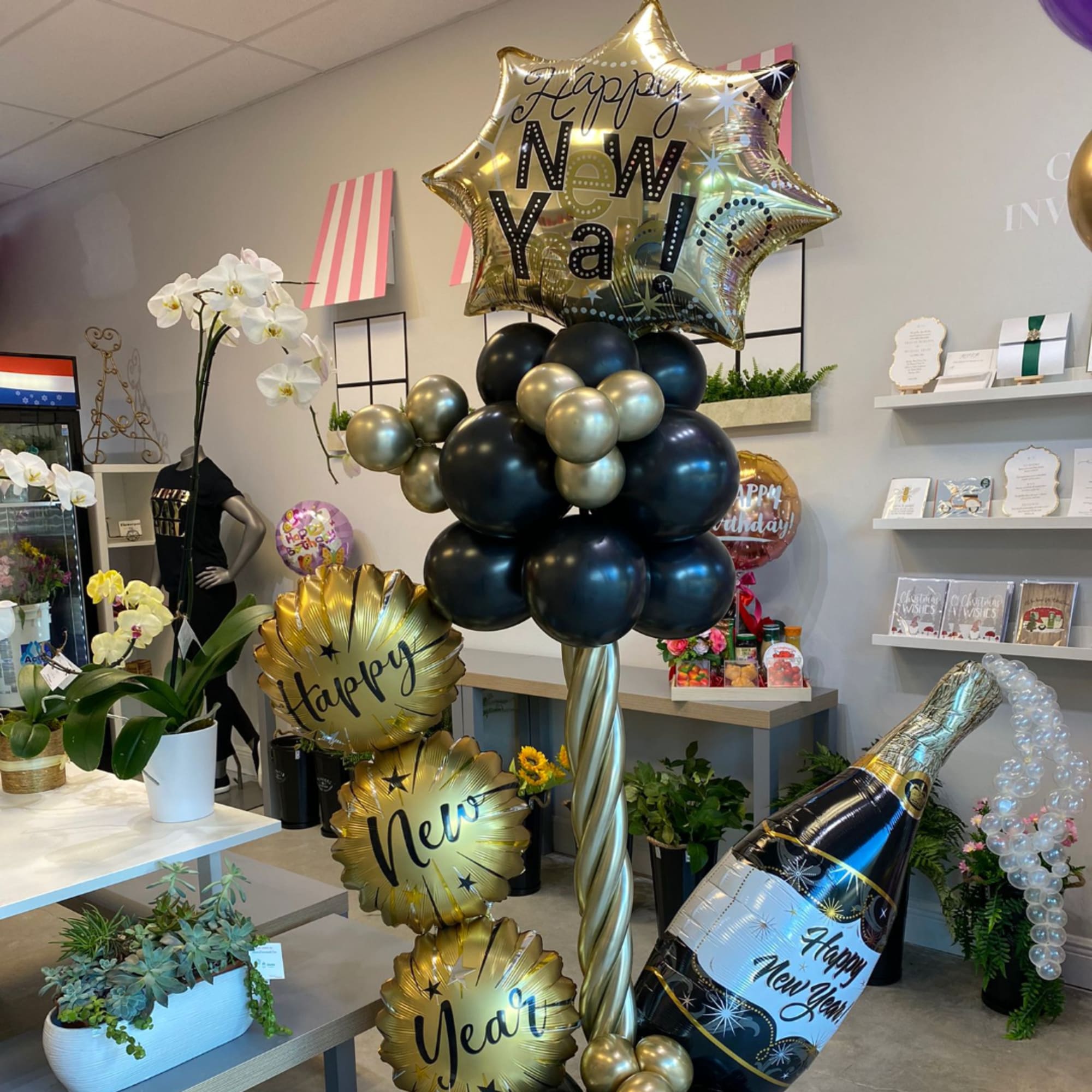 New Year balloon display with gold star and champagne bottle balloons