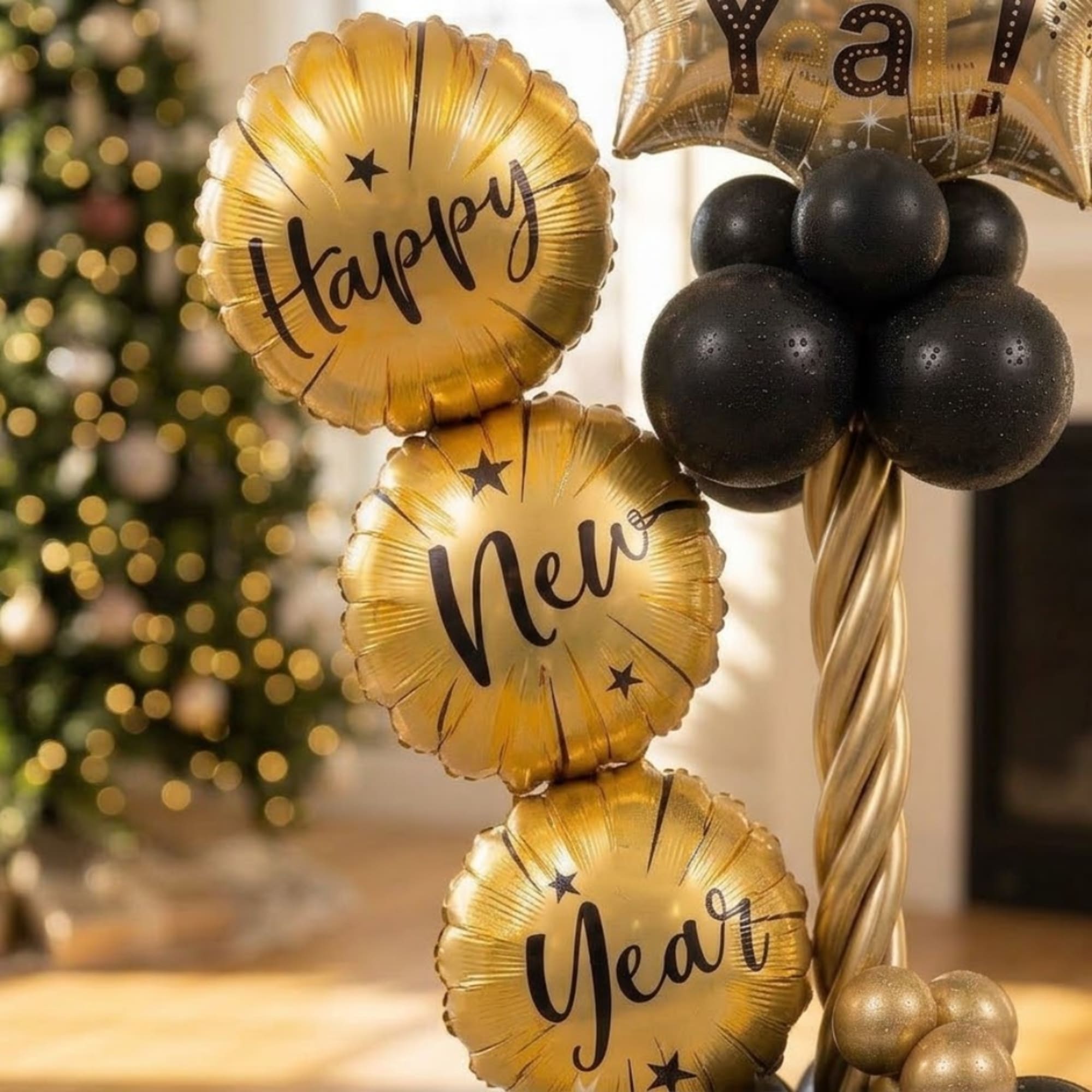 Gold and black New Year balloons arranged in a festive cluster