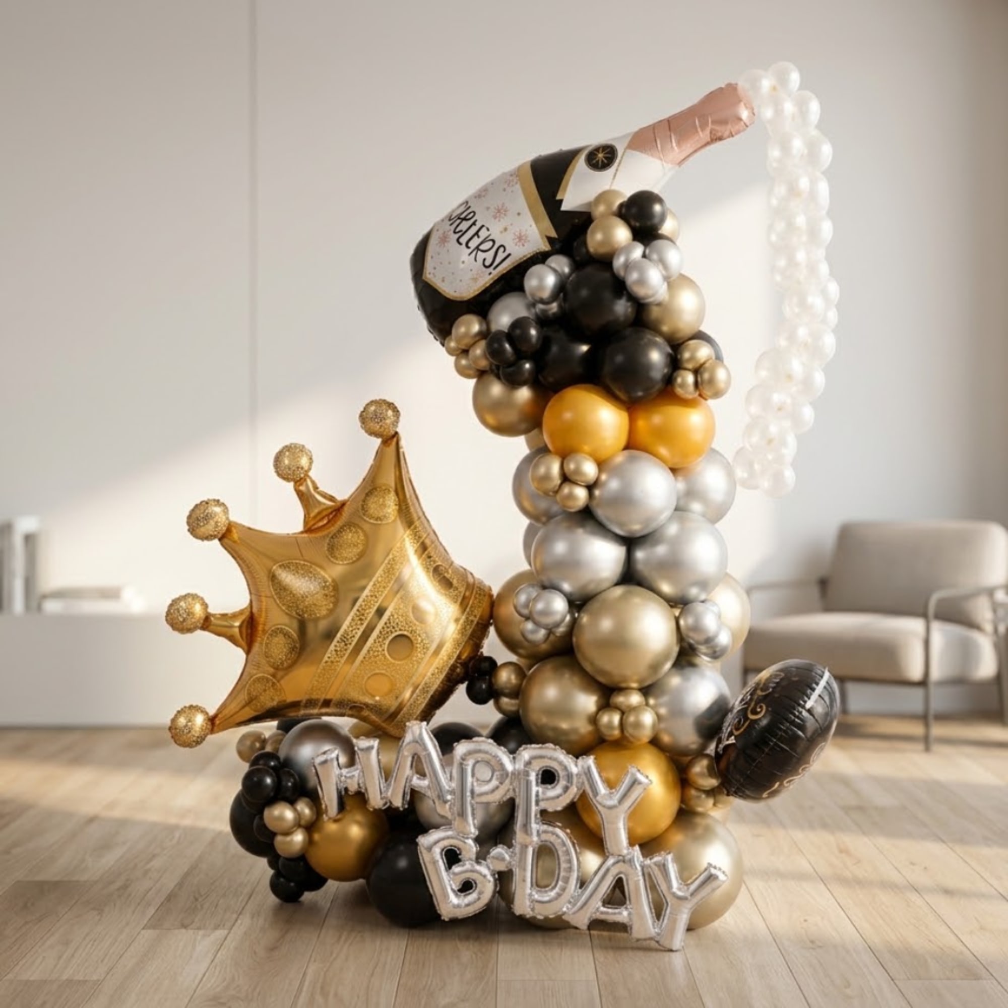 Birthday balloon display with a crown, champagne bottle, and "Happy B-Day" letters